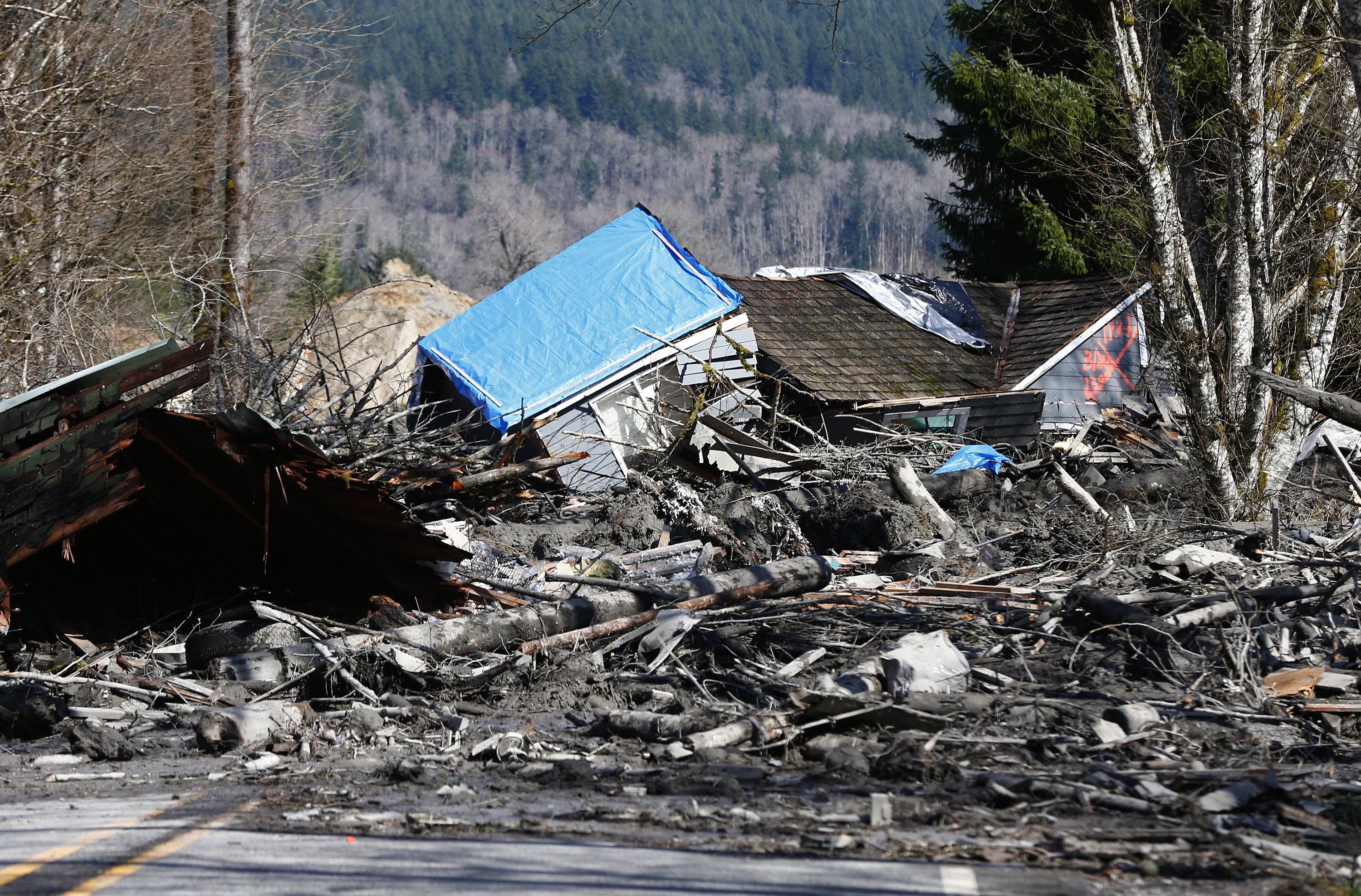 A house is seen destroyed in the mud on Highway 530 next to mile marker 37 on Sunday, March 23, 2014, the day after a giant landslide occurred near mile marker 37 near Oso, Washington.  (AP Photo/The Seattle Times, Lindsey Wasson, Pool)