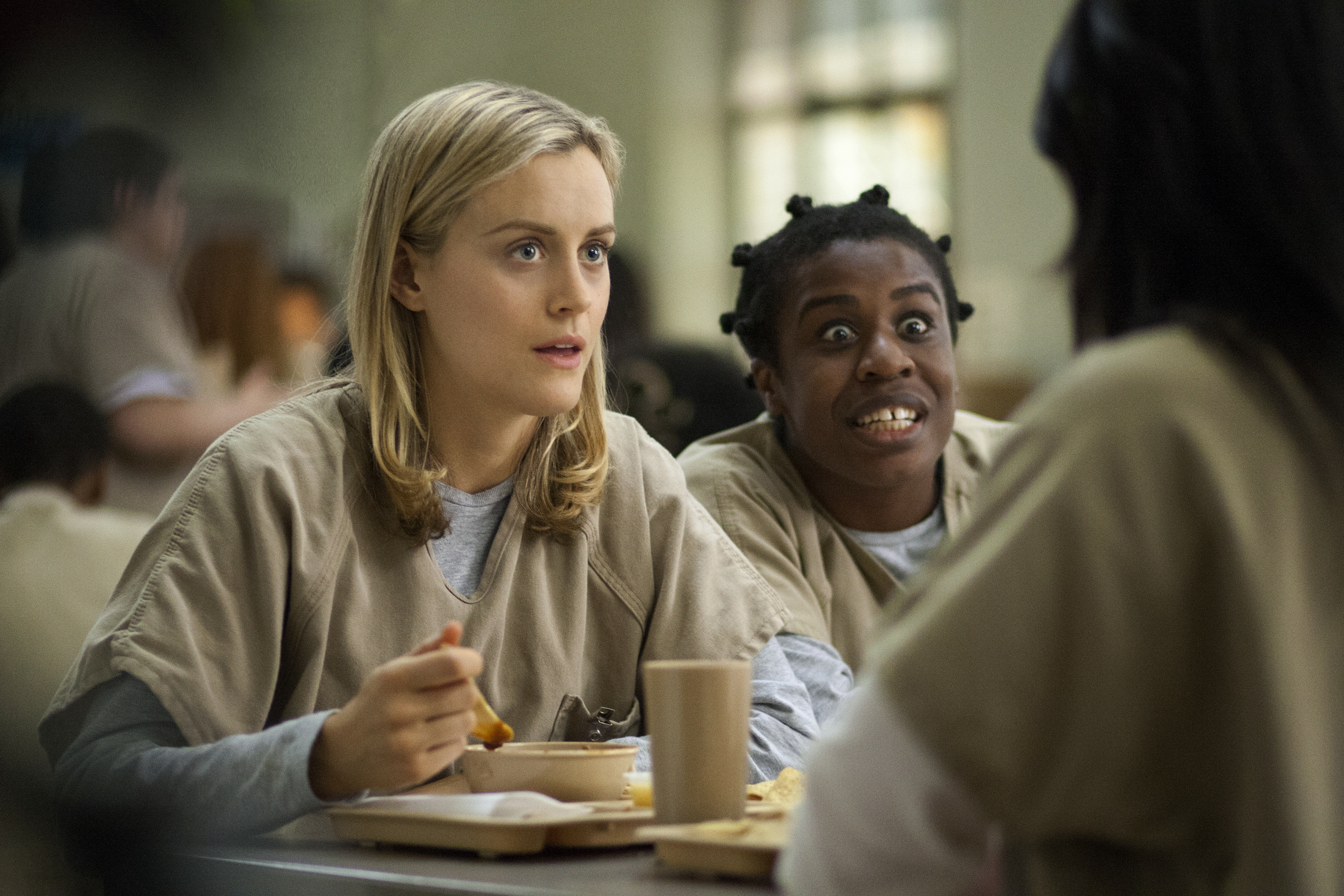 FILE - This image released by Netflix shows Taylor Schilling, left, and Uzo Aduba in a scene from "Orange Is the New Black." Season two debuts on Netflix on June 6, 2014. (AP Photo/Netflix, Paul Schiraldi, file) (AP)
