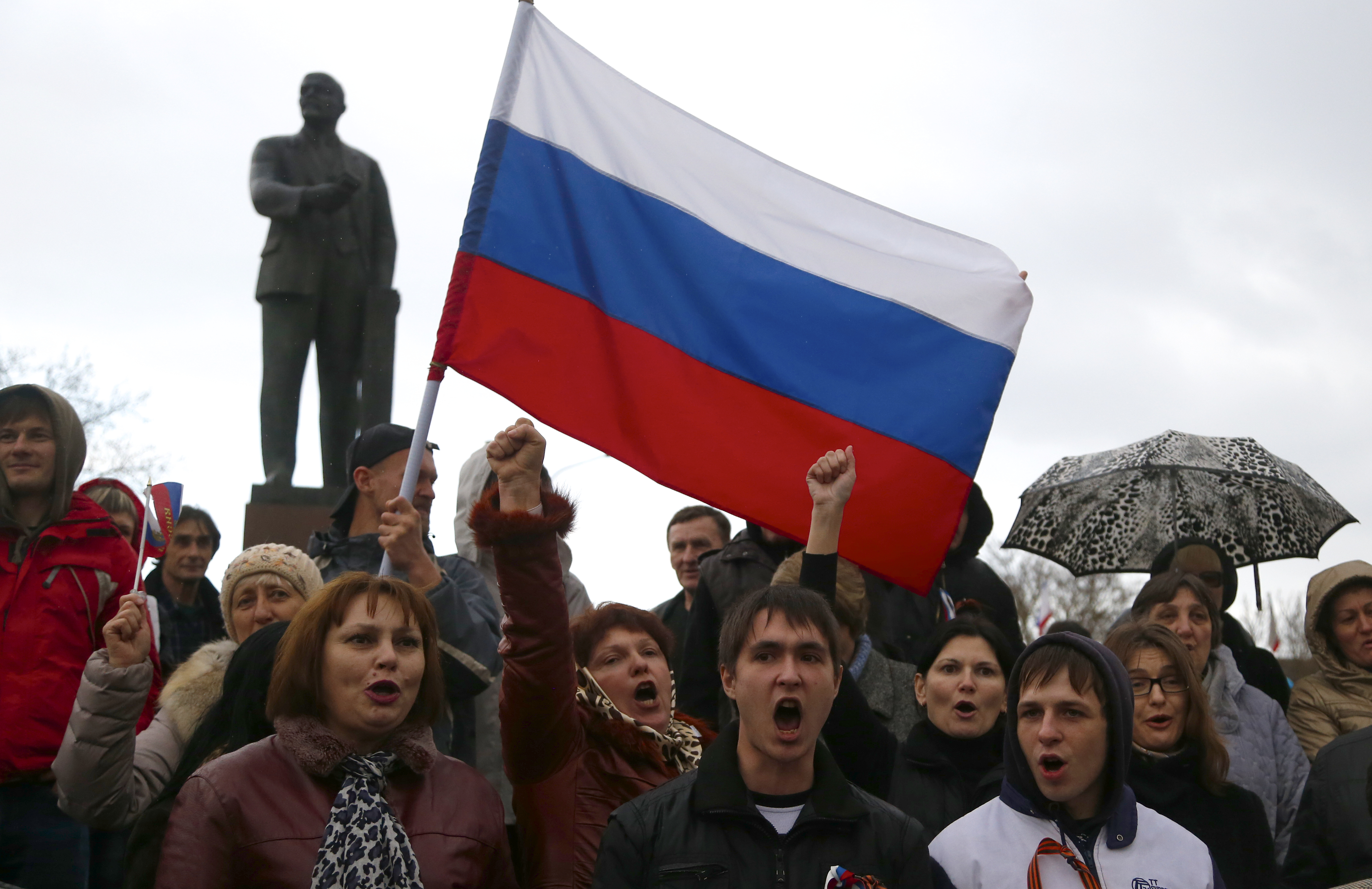 In this photo taken Wednesday, March 5, 2014, pro-russian supporters chant slogans during a rally at a central square in Simferopol, Ukraine. Ukraine is facing a potentially crippling geographic and cultural divide, a growing gulf between supporters of Russia who dominate the east and south of the country, and western Ukrainians who yearn for closer ties to Western Europe.  One side of that divide is even starker in Crimea, a Black Sea peninsula. For much of the past 200 years, Crimea was under Russian and Soviet control, and today most Crimeans see themselves as only nominally Ukrainian and Russian is, by far, the dominant language (AP Photo/Sergei Grits) (AP)