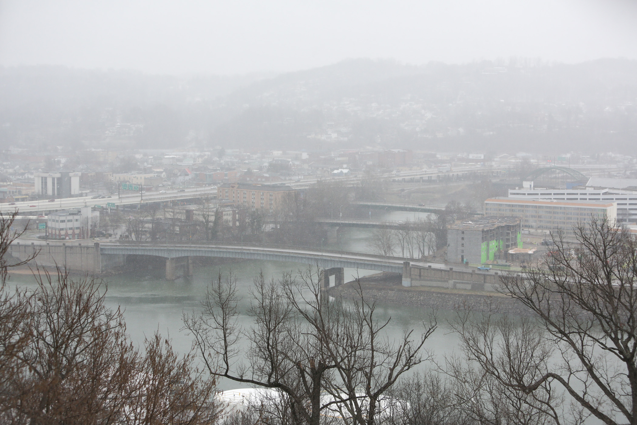 Snow falls over the confluence of the Elk and Kanawha Rivers, Sunday, March 16, 2014, in Charleston, W.Va. (Marcus Constantino)