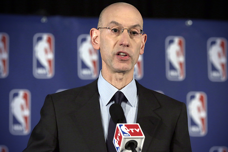 Adam Silver reads a statement during a news conference, in New York, April 29, 2014, announcing that he is banning Los Angeles Clipper owner Donald Sterling for life from the Clippers organization. (AP/Richard Drew)