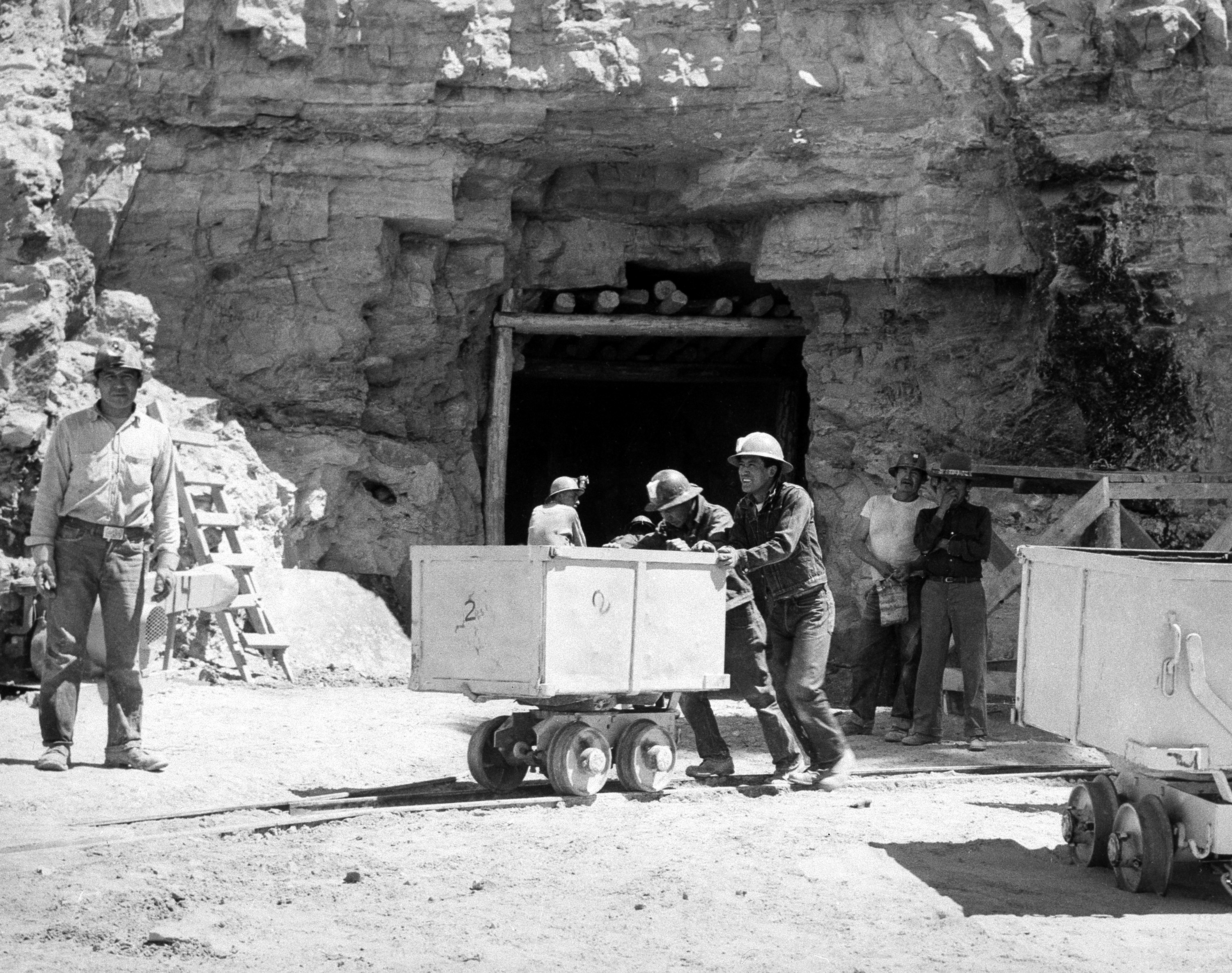 In this May 7, 1953, file photo, Navajo miners work at the Kerr McGee uranium mine at Cove, Ariz., on the Navajo reservation in Arizona. Kerr-McGee left abandoned uranium mine sites, including contaminated waste rock piles, in the Lukachukai mountains of Arizona and in the Ambrosia Lake area of New Mexico. The Lukachukai mountains are located immediately west of Cove, Ariz., and are a culturally significant part of the Navajo Nation. This site is among thousands that are part of the $5.15 billion settlement with Anadarko Petroleum Corp. with approximate amount of funding for cleanup efforts and details about the sites, in information provided by the Justice Department.  (AP Photo)