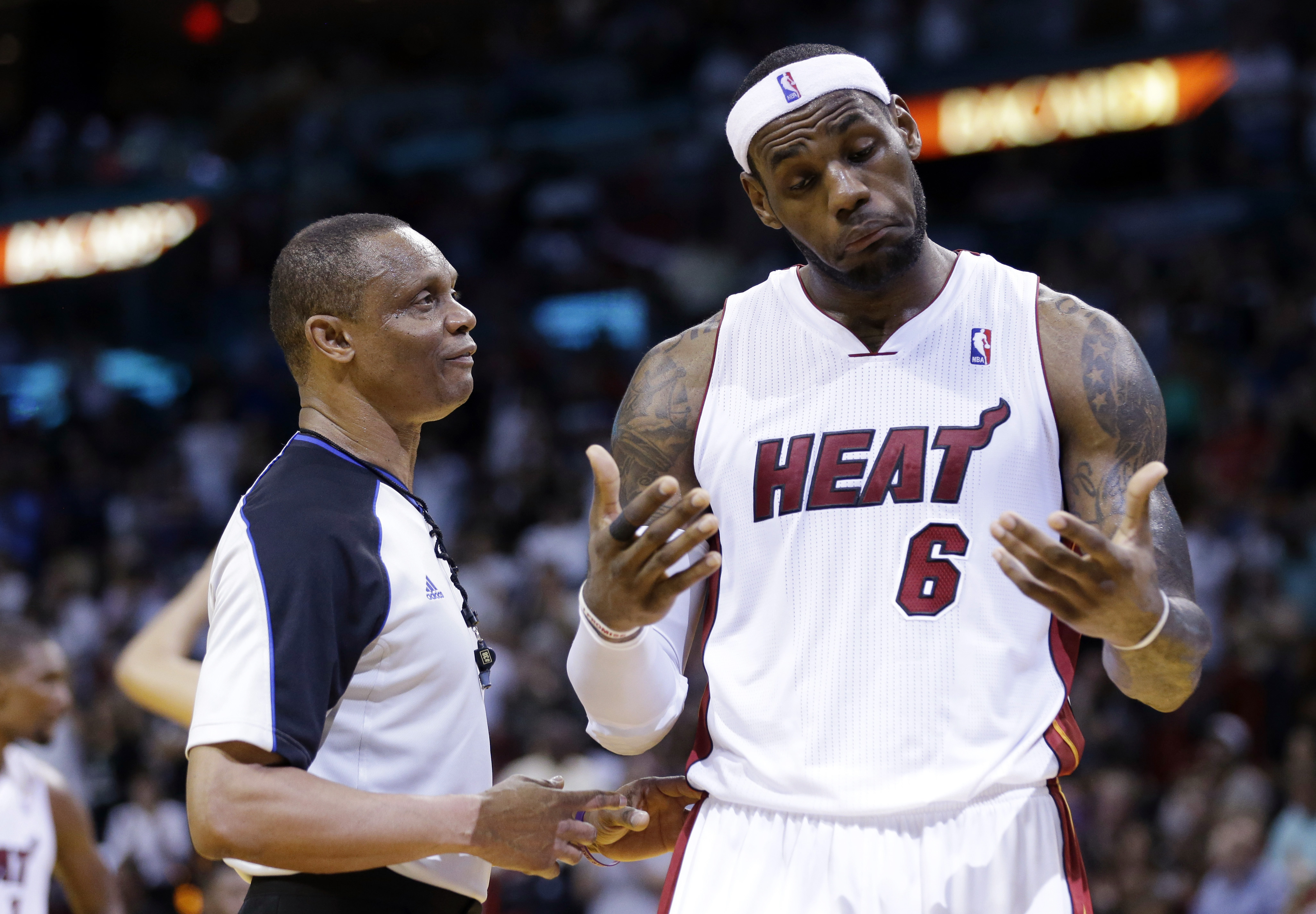 Miami Heat's LeBron James, right, reacts as he talks with official Michael Smith during the second half of an NBA basketball game against the Indiana Pacers, Friday, April 11, 2014, in Miami. The Heat defeated the Pacers 98-86. (AP Photo/Lynne Sladky) (AP)