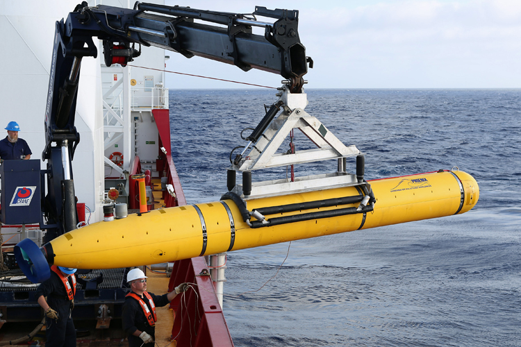 Crew move the U.S. Navy's Bluefin-21 autonomous underwater vehicle into position for deployment in the southern Indian Ocean, April 14, 2014. (Reuters/Peter D. Blair)