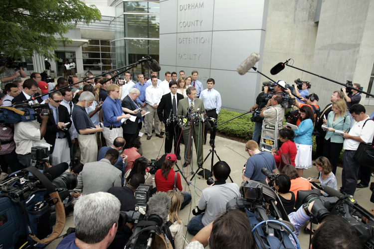 Joe Cheshire, attorney, at podium, and David Evans, senior captain of the Duke lacrosse team, right, make a statement in front of the Durham County Detention Center, May 15, 2006. (AP/Gerry Broome)