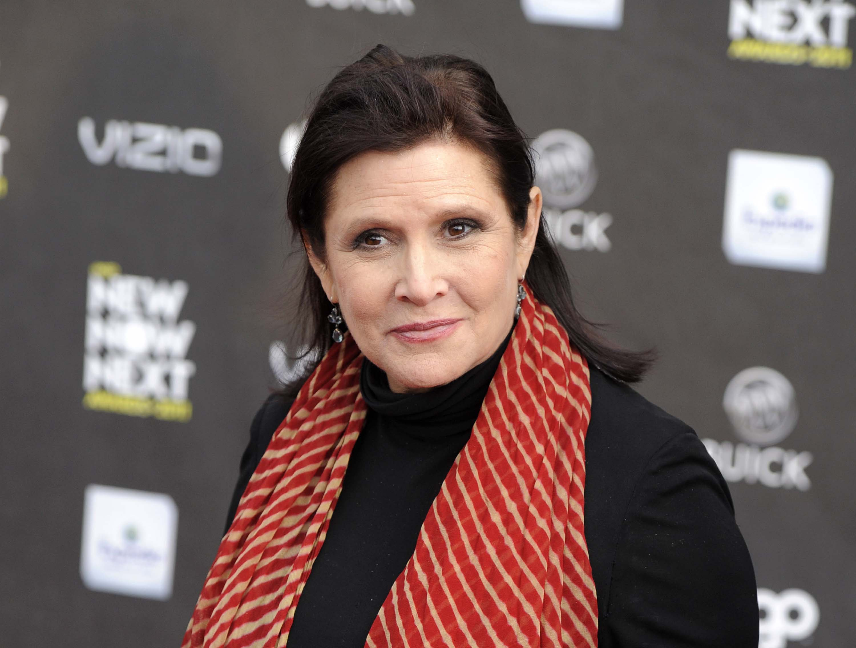 FILE - This April 7, 2011 file photo shows Carrie Fisher at the 2011 NewNowNext Awards in Los Angeles. After months of carefully guarded secrecy and endless Internet speculation, the cast of the latest incarnation of the space epic,  "Star Wars: Episode VII," was unveiled Tuesday, April 29, 2014, on the official "Star Wars" website by Lucasfilm and the Walt Disney Co. The "Episode VII" cast is a mix of fresh faces, up-and-comers and established names, including veterans Harrison Ford, Mark Hamill and Fisher. (AP Photo/Chris Pizzello, file) (AP)