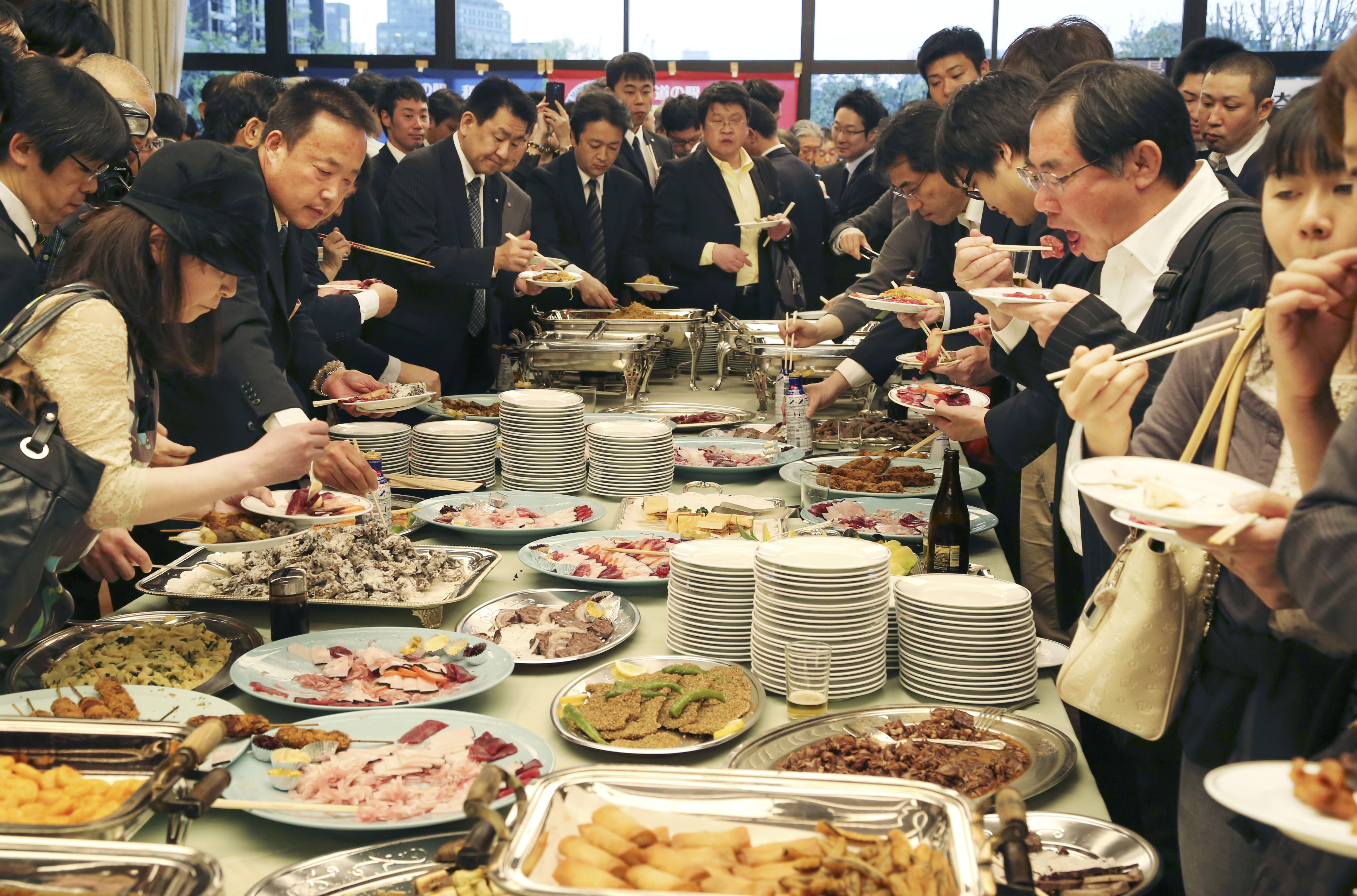 Supporters of whaling eat meat of whale during a meeting of the 26th support whaling event in Tokyo, Tuesday, April 15, 2014. (AP Photo/Koji Sasahara) (Koji Sasahara)
