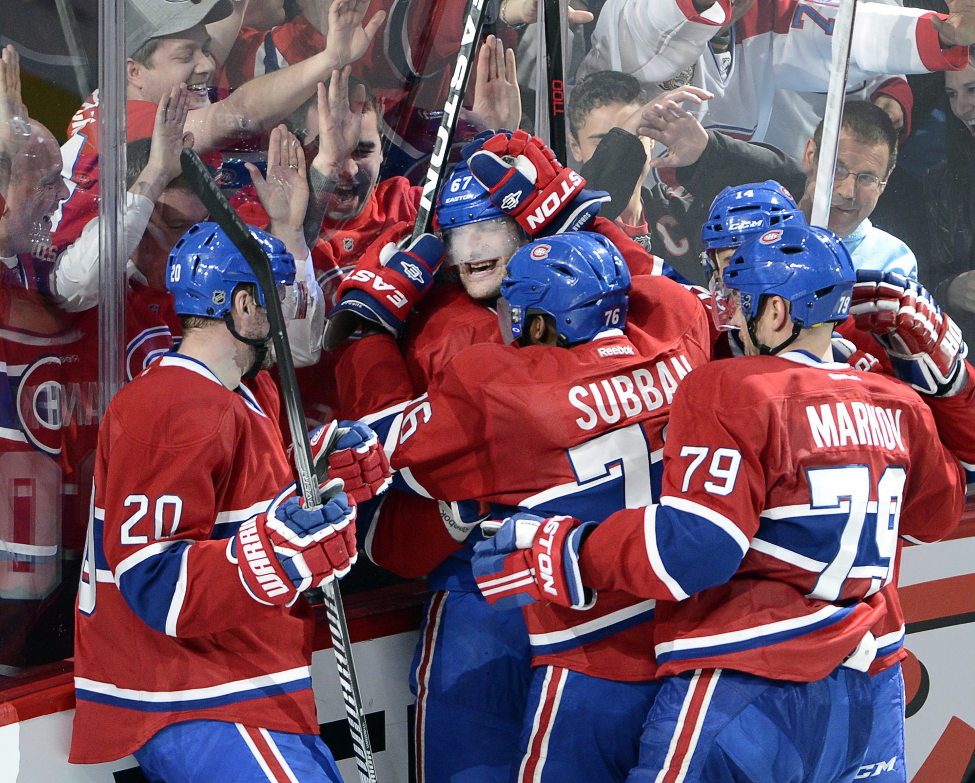 Montreal Canadiens left wing Max Pacioretty (67) is mobbed by teammates after scoring the winning goal against the Tampa Bay Lightning during third period National Hockey League Stanley Cup playoff action on Tuesday, April 22, 2014 in Montreal. (AP Photo/The Canadian Press, Ryan Remiorz) (AP)
