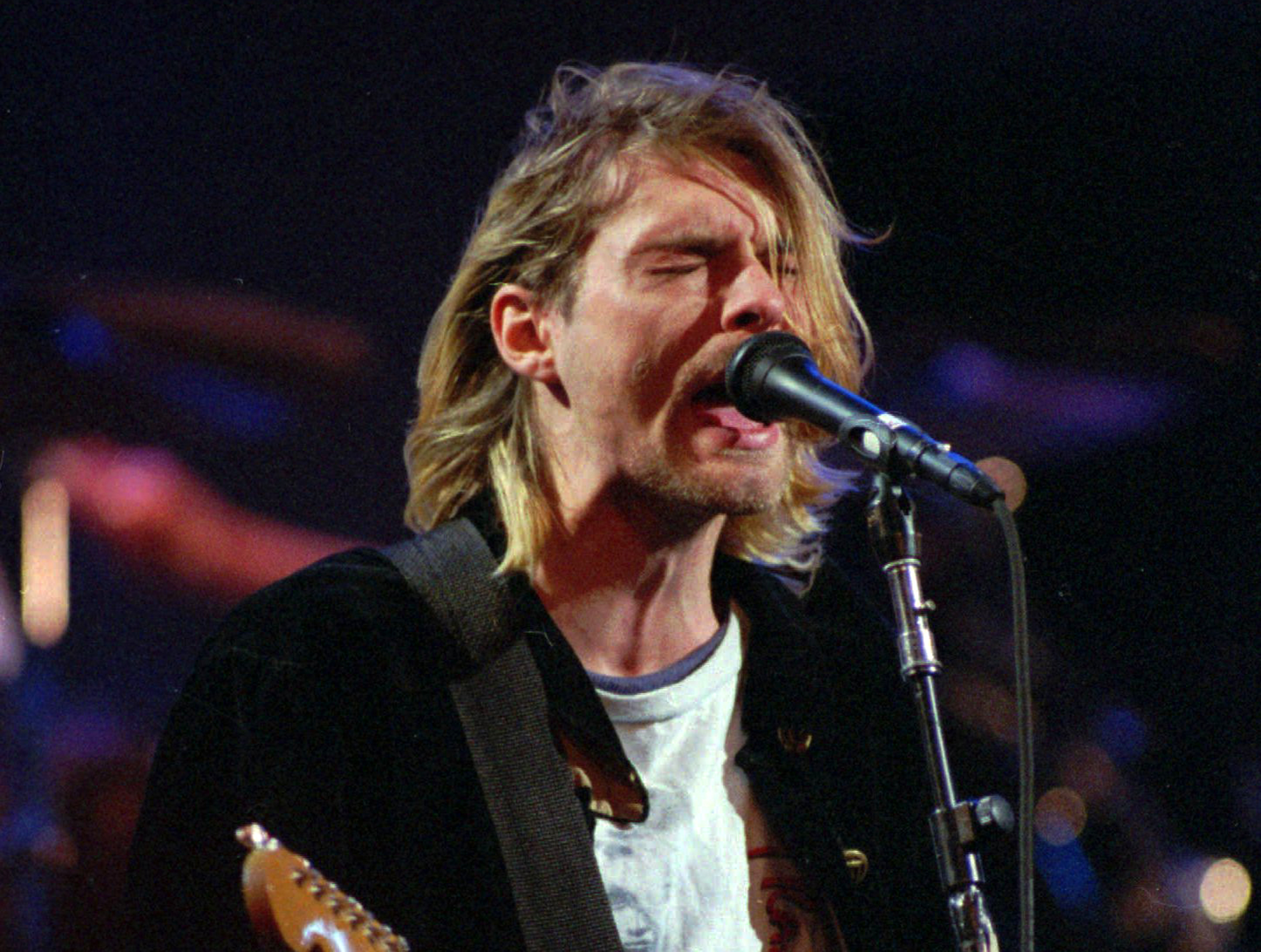 This Dec. 13, 1993 file photo shows Kurt Cobain of the Seattle band Nirvana performing in Seattle, Wash. Nirvana, which changed music and fashion in the 1990s with the punk rock-inspired grunge sound, is joining the Rock and Roll Hall of Fame in a class with Kiss, Peter Gabriel and Hall & Oates. Nirvana is being inducted in its first year of eligibility. The trio's "Smells Like Teen Spirit" hit like a thunderclap upon its 1991 release, briefly making the Pacific Northwest rock's hottest scene before the band ended abruptly with singer Kurt Cobain's suicide in 1994. (AP Photo/Robert Sorbo)