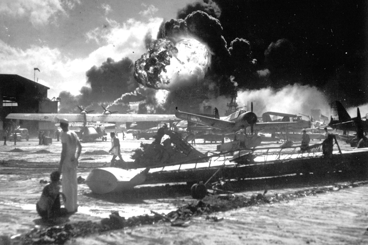 Sailors watch the explosion of the USS Shaw in the background, during the Japanese attack on Pearl Harbor, Hawaii, Dec. 7, 1941. (AP)