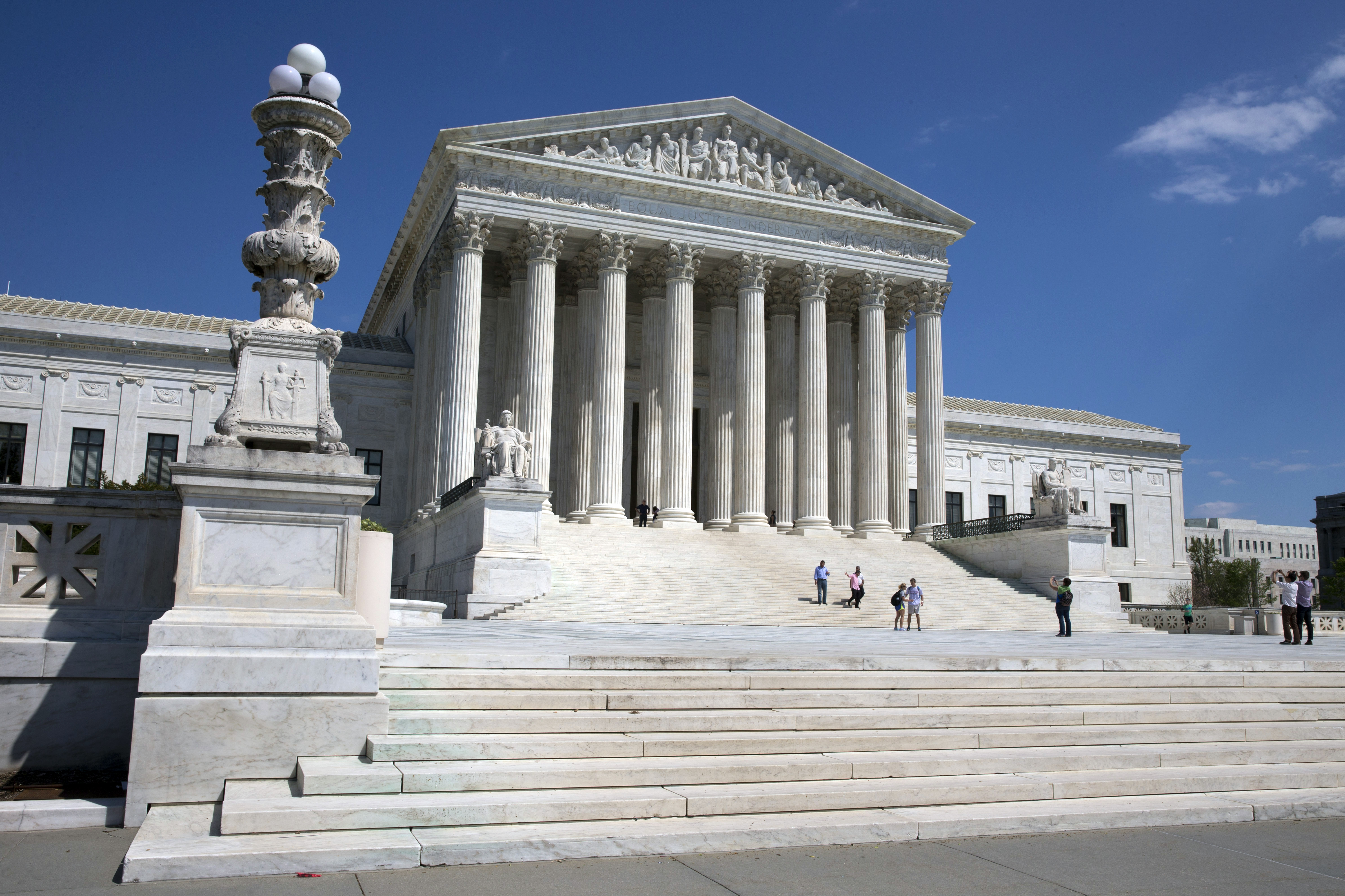 People walk on the steps of the U.S. Supreme Court in Washington on Saturday April 26, 2014. ((AP Photo/Jacquelyn Martin))