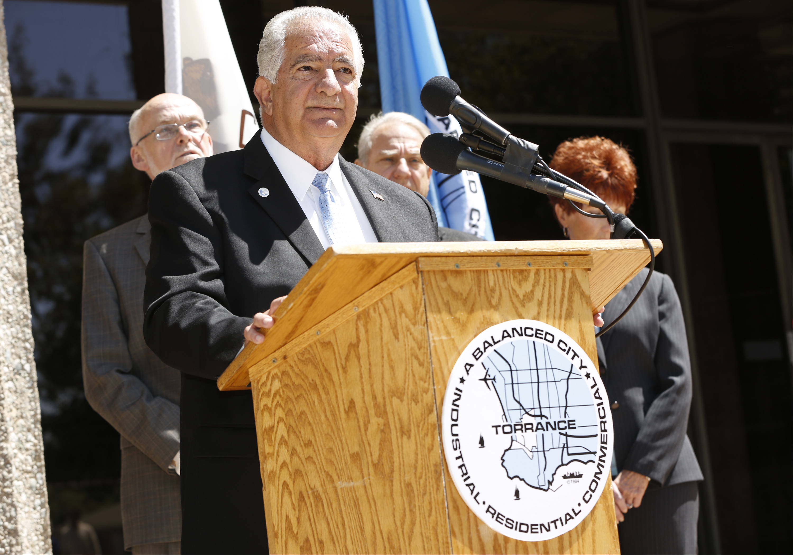 Torrance Mayor Frank Scotto, at podium, holds a news conference to discuss the announced relocation of Toyota Motor Sales' U.S. headquarters, Monday, April 28, 2014, in front of City Hall in Torrance, Calif.  Toyota said that it will move its U.S. headquarters from Torrance to Plano, Texas, a suburb of Dallas. Small groups of employees will start moving to temporary office space there this year, but most will not move until late 2016 or early 2017 when a new headquarters is completed.  (AP Photo/Damian Dovarganes) (AP)