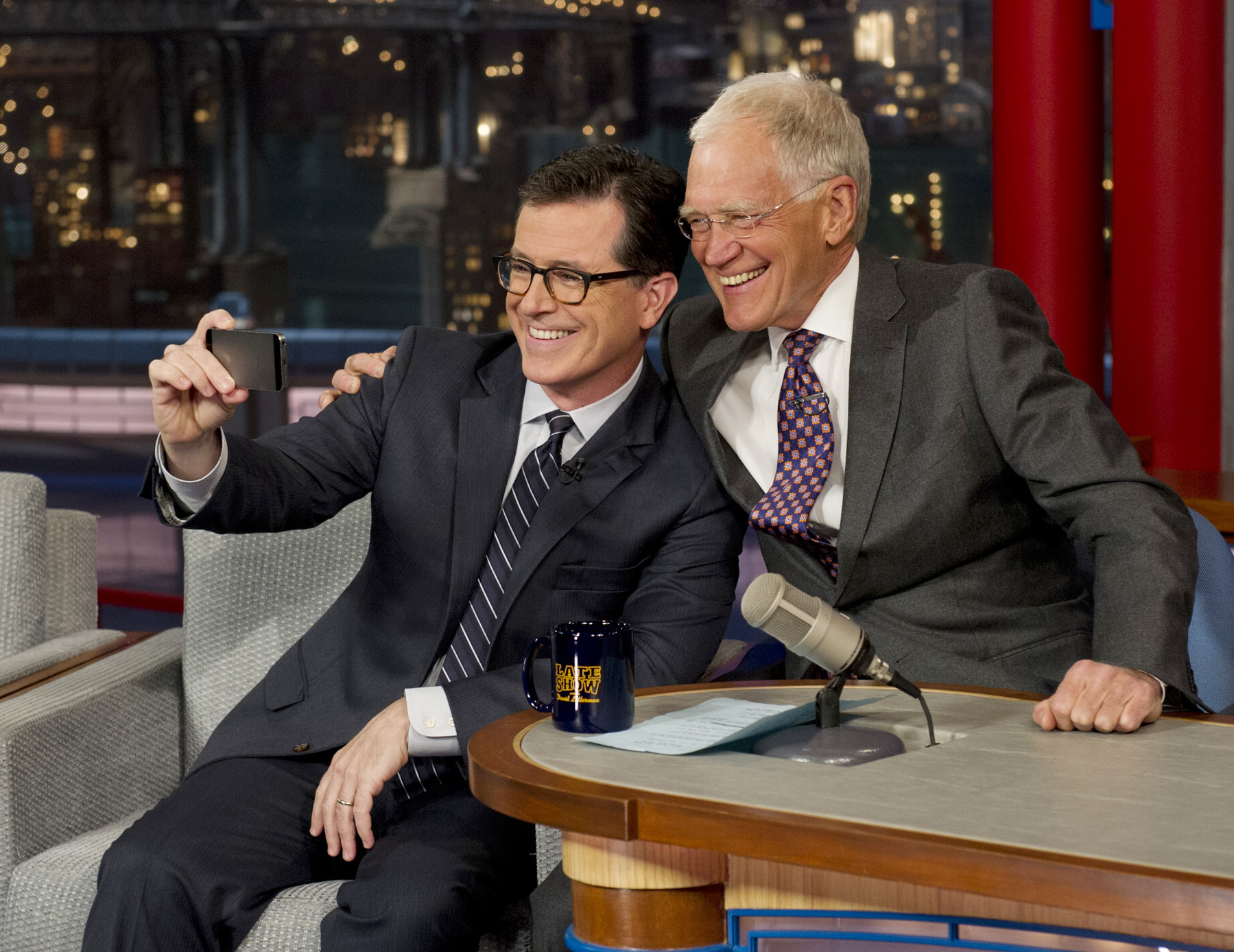 In this photo provided by CBS, Comedy Centrals Stephen Colbert, left, takes a selfie with host David Letterman on the set of the Late Show with David Letterman, Tuesday, April 22, 2014 in New York. This was Colberts first visit to the show since CBS announced that he will succeed Letterman as host when he retires in 2015. (AP Photo/Jeffrey R. Staab) MANDATORY CREDIT, NO SALES, NO ARCHIVE, FOR NORTH AMERICAN USE ONLY (AP)