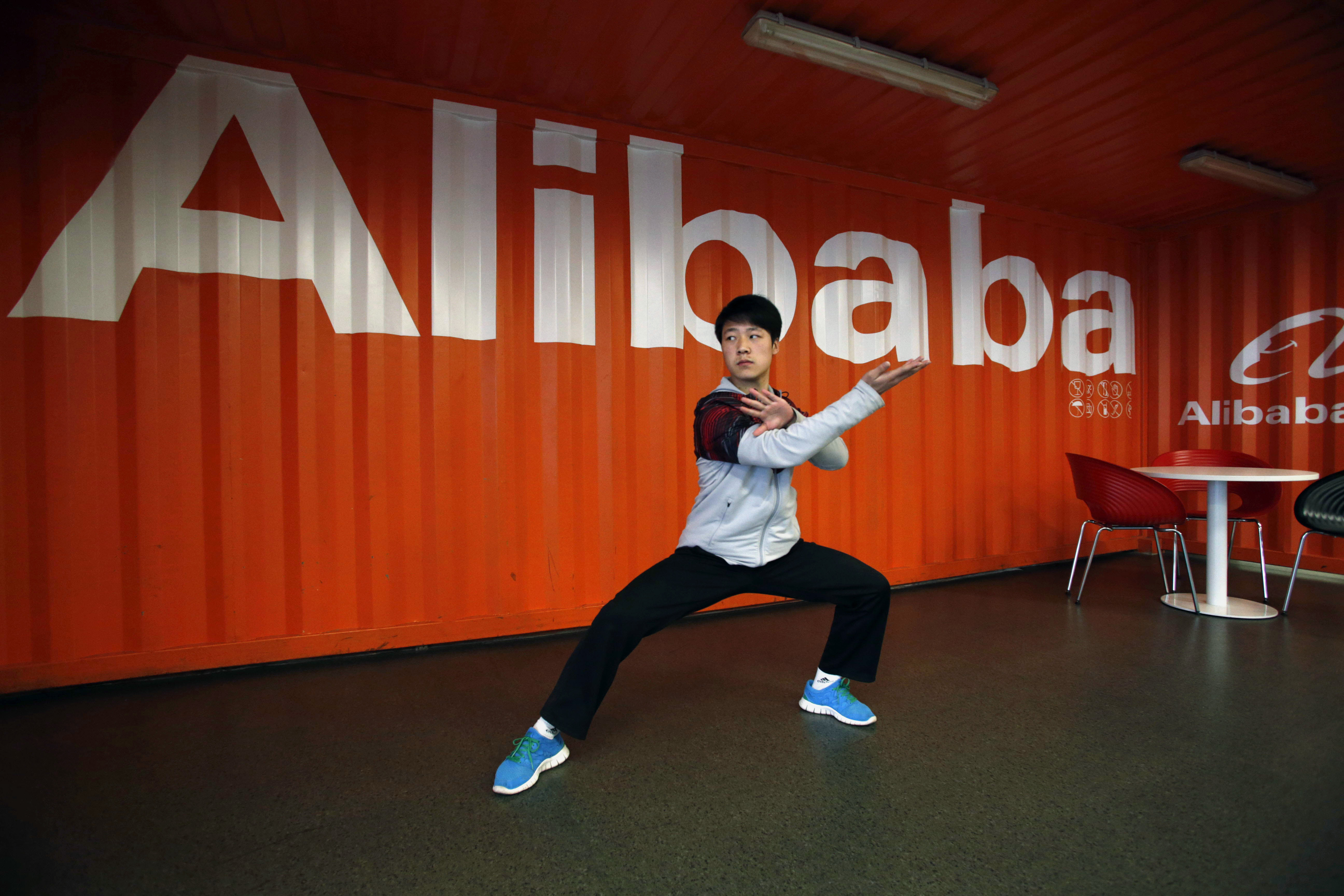 In this file photo taken Tuesday March 26, 2013, a worker performs shadow boxing during an open day at the Alibaba Group office in Hangzhou in east China's Zhejiang province. (AP Photo)