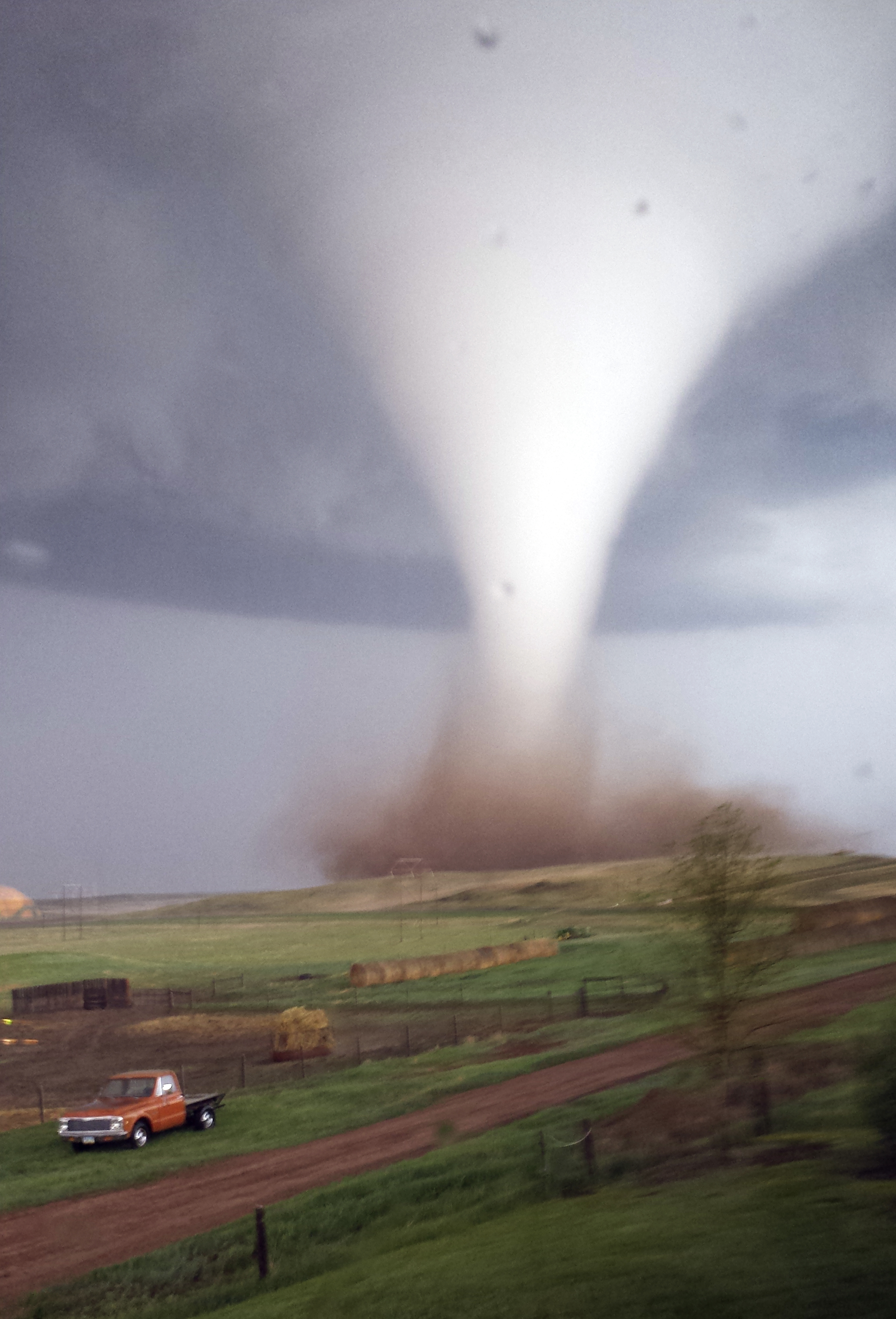 This photo taken on Monday, May 26, 2014 and provided by Jill Helmuth, shows a tornado touching down on a reach before heading towards Watford City, N.D. Authorities say several were injured and more than a dozen trailers were damaged or destroyed Monday evening when the twister tore through a camp where oil field workers stay. (AP Photo/Jill Helmuth) (AP)