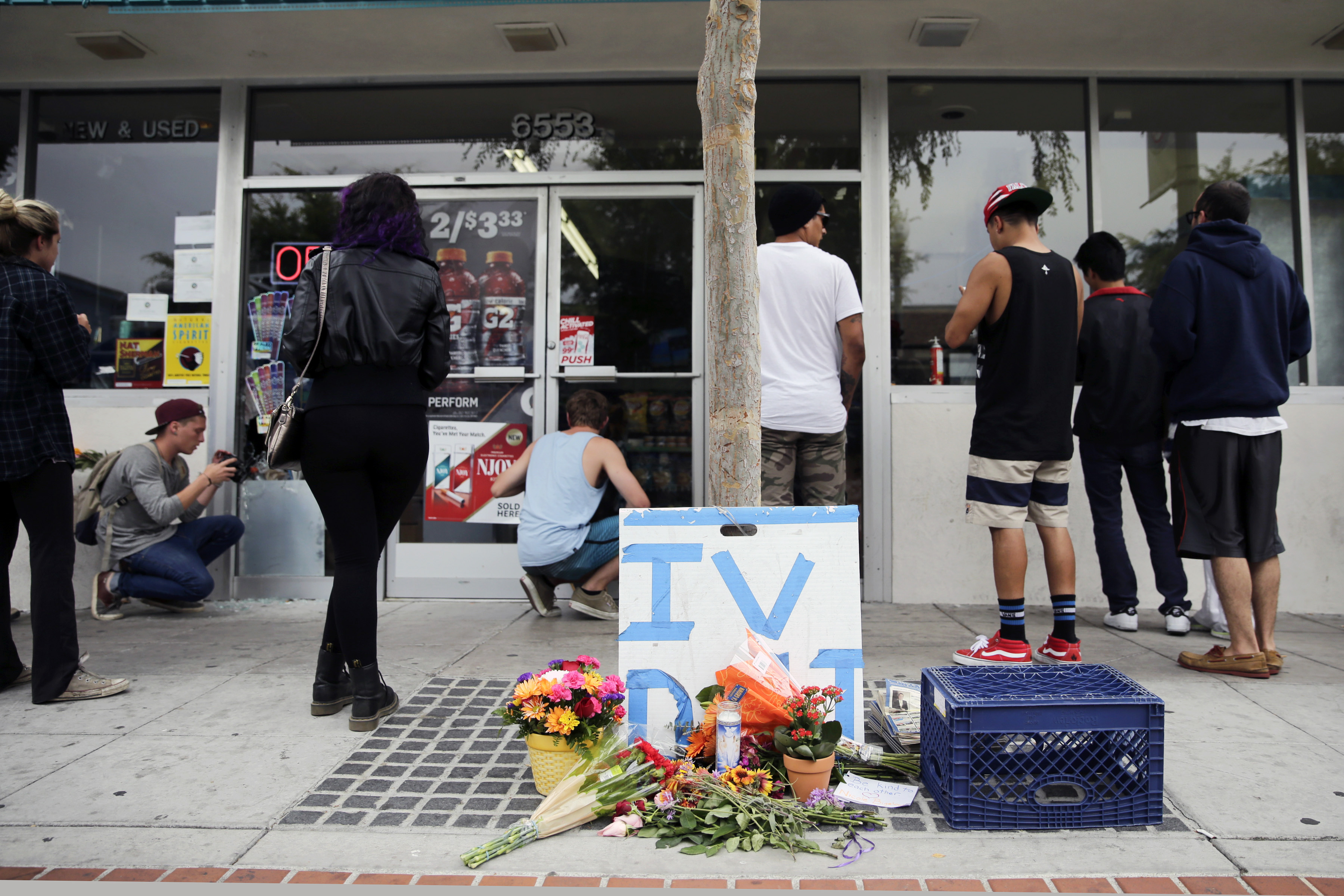 Some flowers are left in front of IV Deli Mart, where part of Friday night's mass shooting took place by a drive-by shooter, on Saturday, May 24, 2014, in Isla Vista, Calif. Alan Shifman, a lawyer who represents Hollywood director Peter Rodger, says the family believes Rodgers son, Elliot Rodger, was the lone gunman who went on the shooting rampage near the University of California at Santa Barbara. ((AP Photo/Jae C. Hong))