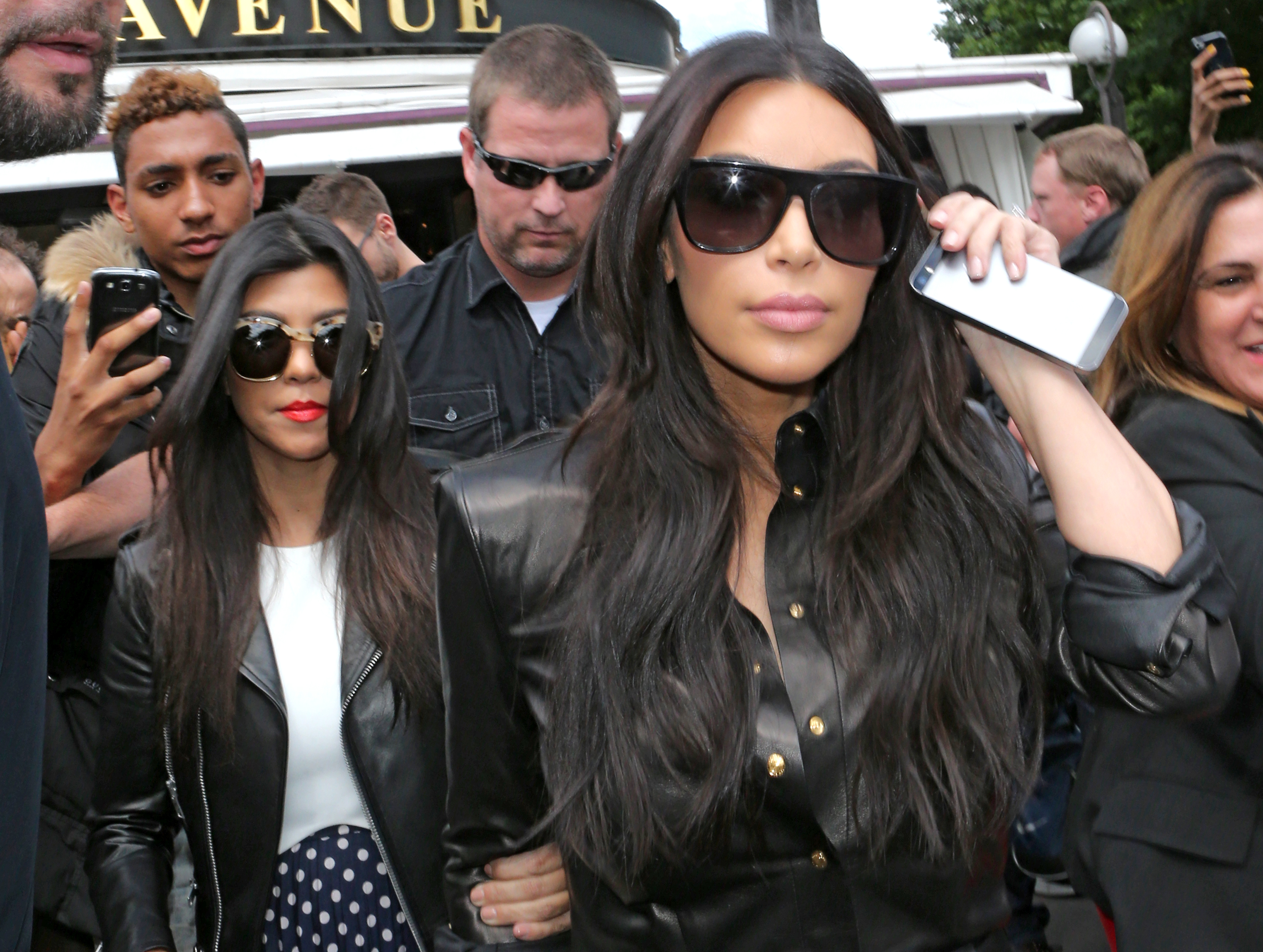 Kim Kardashian, front and Kourtney Kardashian, left, leave at a restaurant in Paris, Thursday, May 22, 2014. (AP Photo/Jacques Brinon)