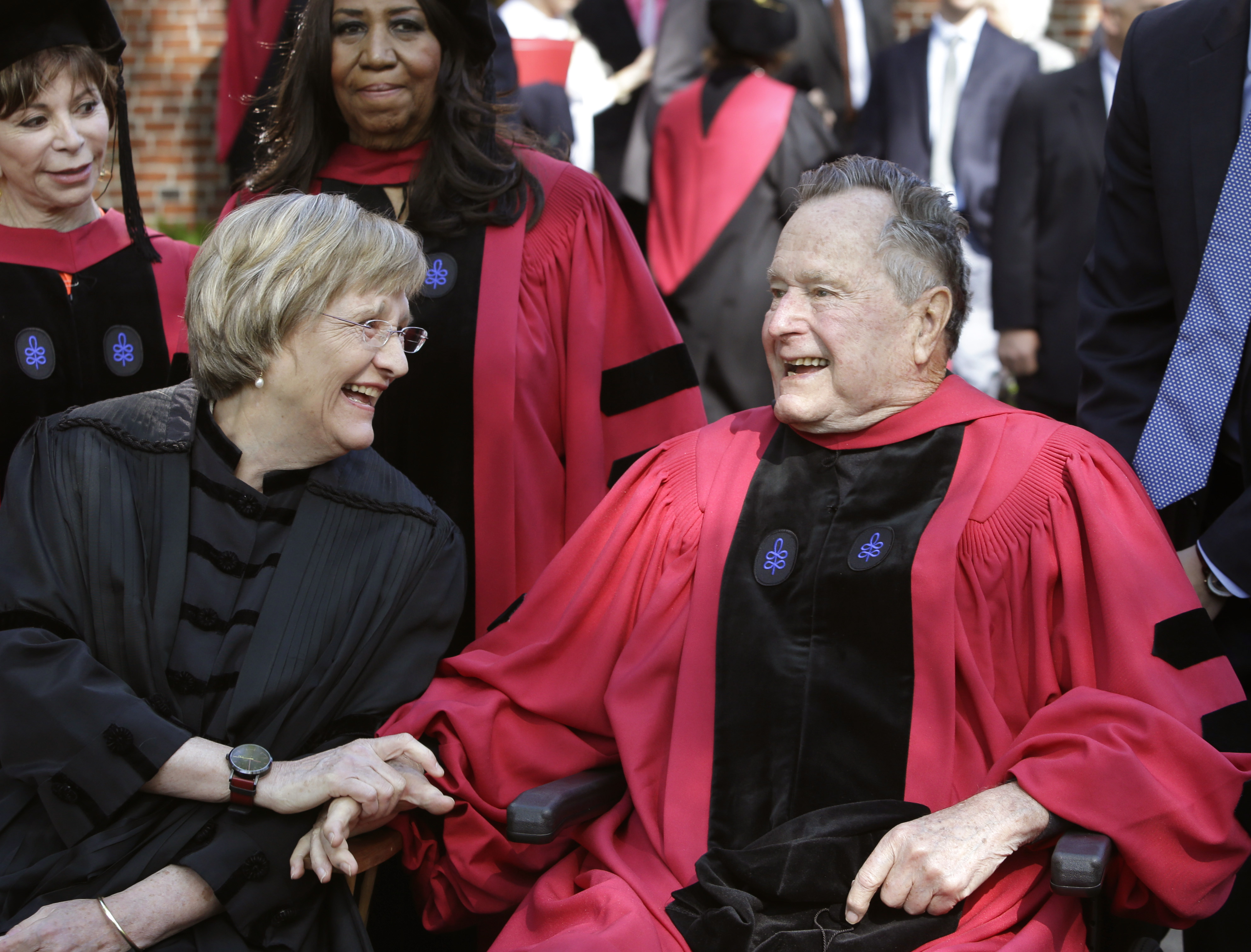 Harvard University President Drew Faust, left, speaks with former President George H. W. Bush, right, before Harvard commencement ceremonies, Thursday, May 29, 2014, in Cambridge, Mass. (AP Photo/Steven Senne)