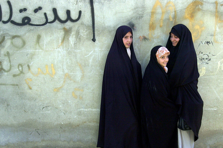 Three Iranian girls wearing traditional chadors at a mosque in northern Tehran. (AP/Enric Marti)