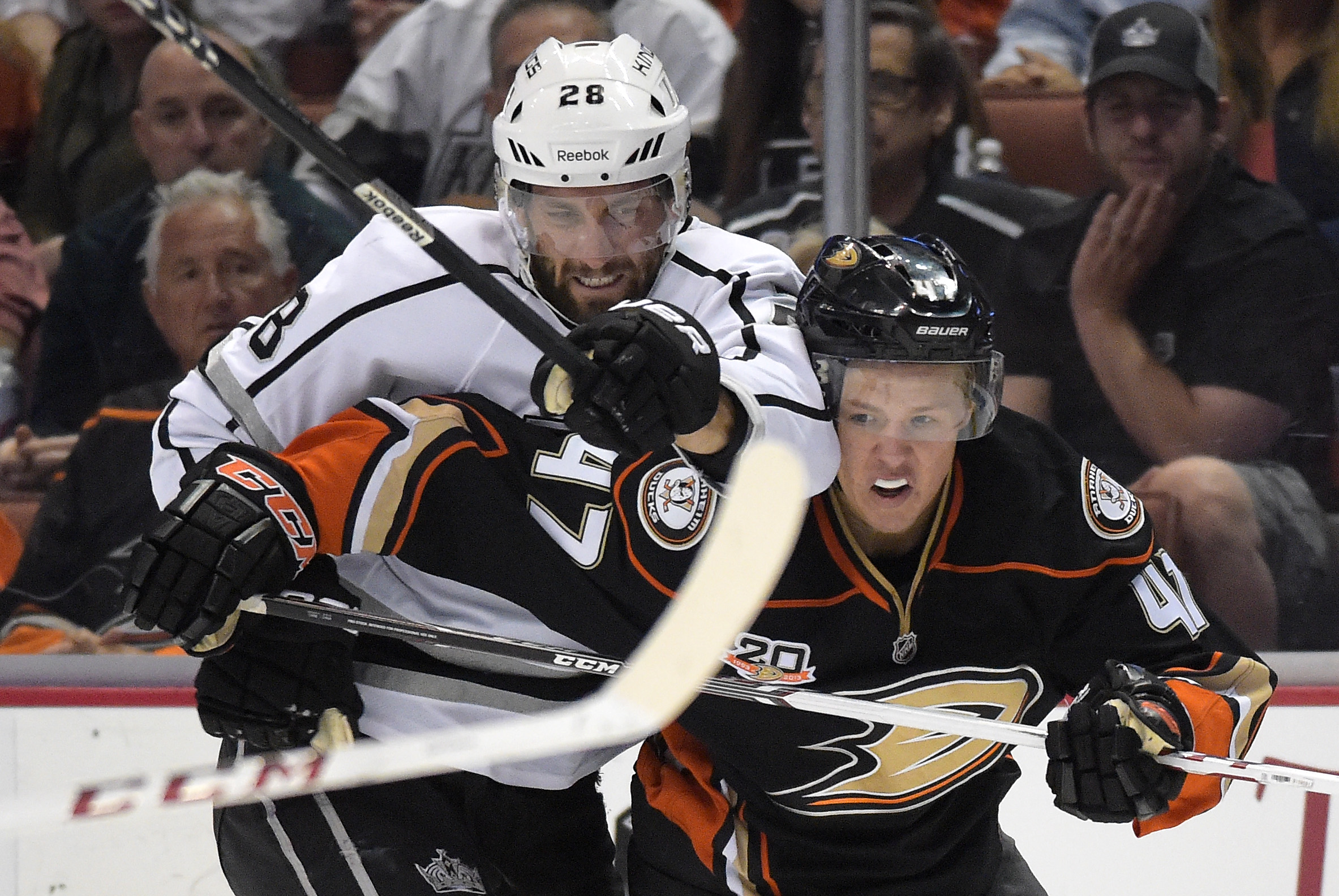Los Angeles Kings center Jarret Stoll, left, and Anaheim Ducks defenseman Hampus Lindholm, of Sweden, battle for the puck during the first period in Game 2 of an NHL hockey second-round Stanley Cup playoff series, Monday, May 5, 2014, in Anaheim, Calif.  (AP Photo/Mark J. Terrill) (AP)
