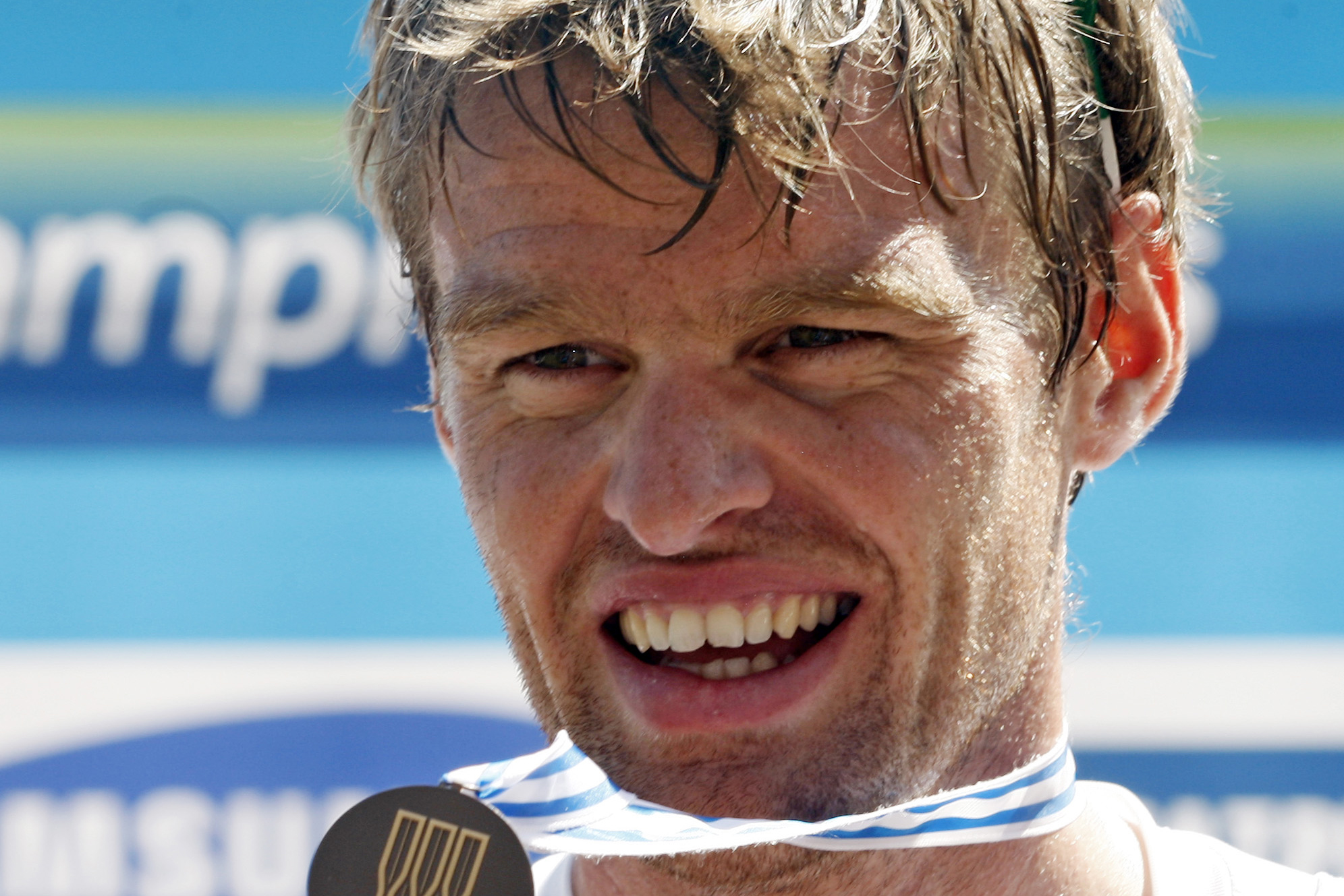 FILE -  In this Saturday, Sept. 3, 2011 file photo, British rower Alan Campbell displays his bronze medal on the podium after the Men's Single Sculls Final event at the World Rowing Championships in Bled, Slovenia. Campbell, whose abscessed lower-left wisdom tooth threatened to keep him from the 2008 Beijing Olympics, is certain that taking better care of his teeth has helped him row faster.  (AP Photo/Filip Horvat, File) (AP)