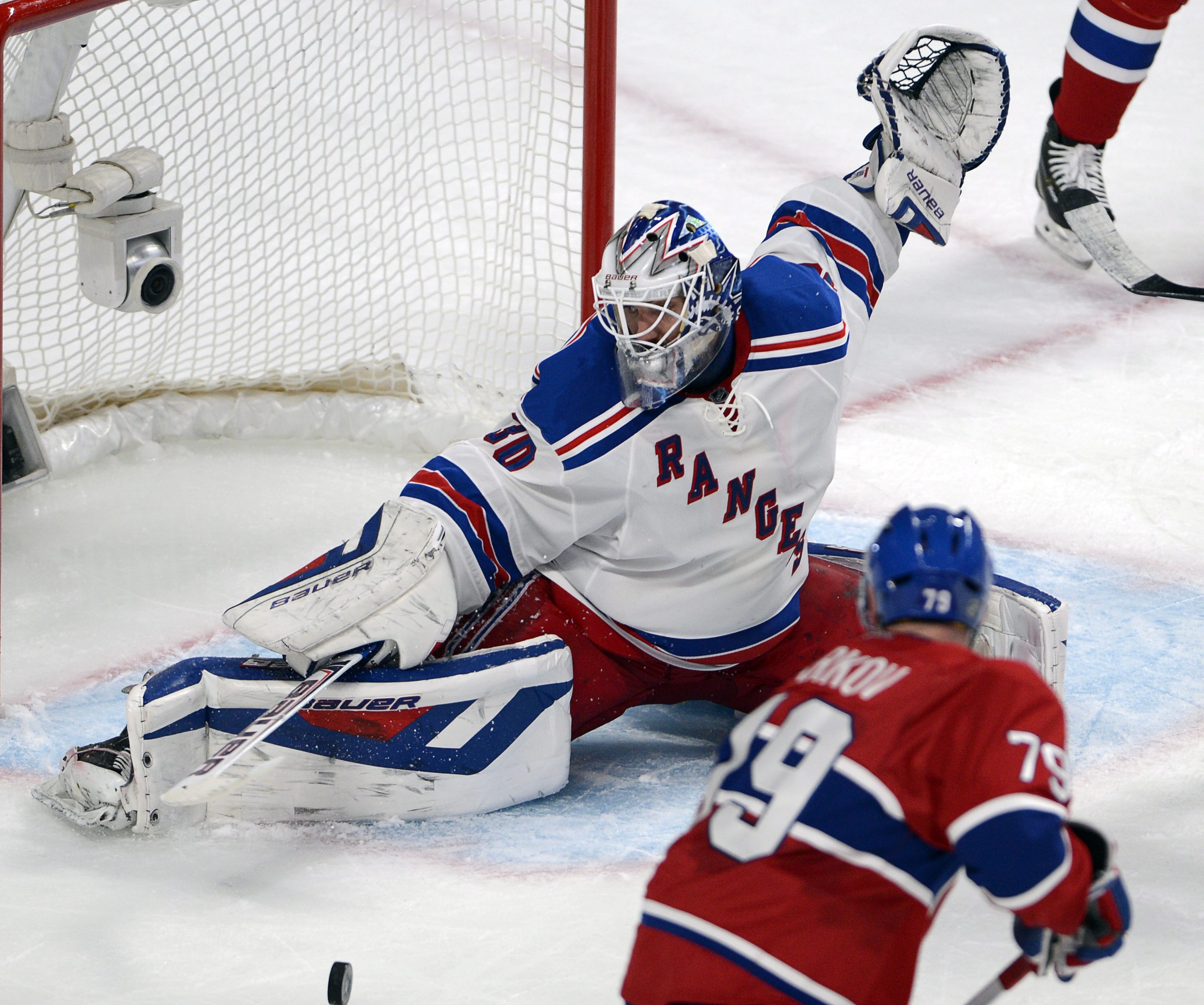 New York Rangers goalie Henrik Lundqvist (30) stops Montreal Canadiens defenseman Andrei Markov (79) during the third period in Game 2 of the NHL hockey Eastern Conference final Stanley Cup playoff series Monday, May 19, 2014, in Montreal. (AP Photo/The Canadian Press, Ryan Remiorz) (AP)