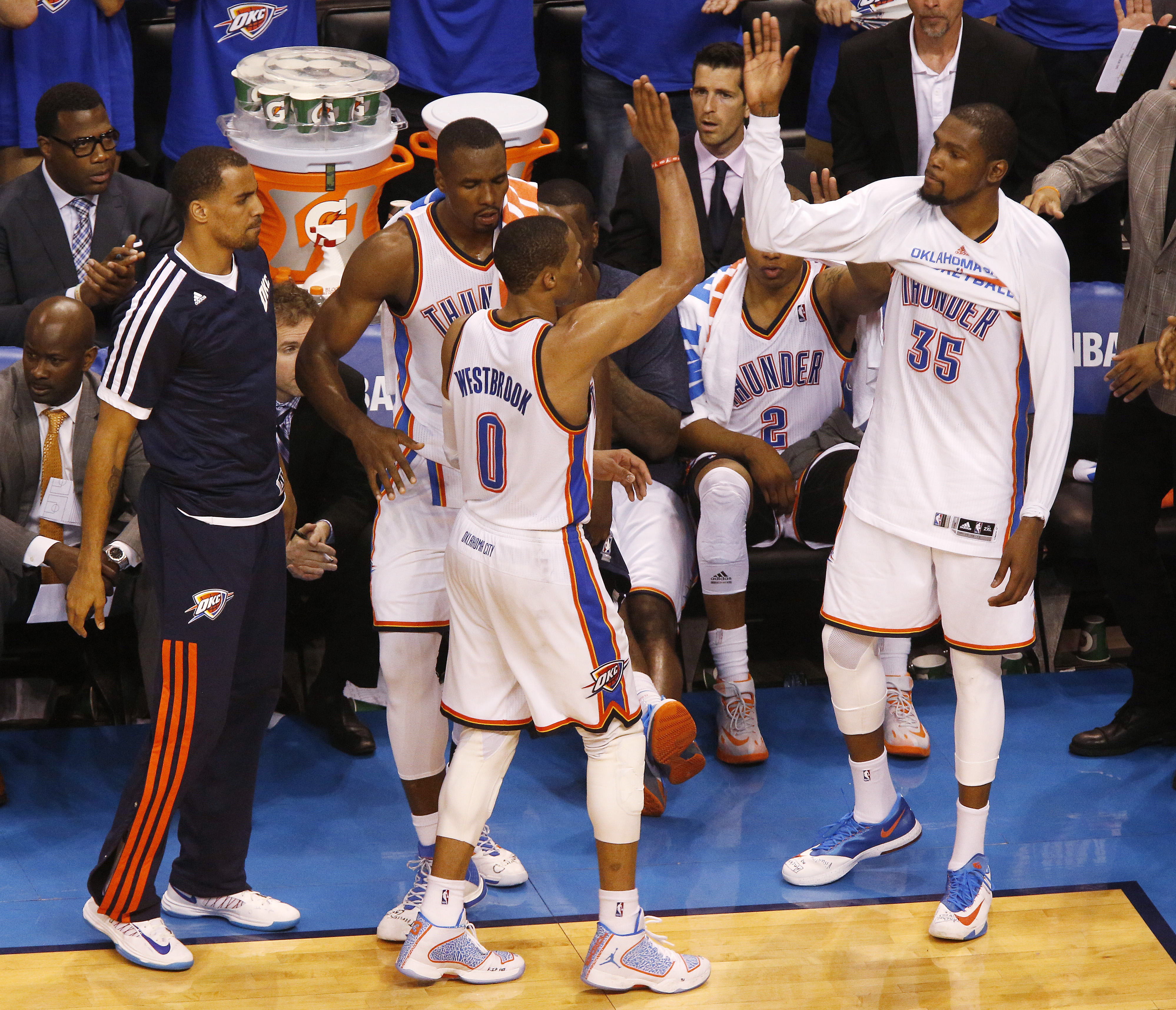 Oklahoma City Thunder guard Russell Westbrook (0) is greeted by teammates, guard Thabo Sefolosha (25), forward Serge Ibaka (9), and forward Kevin Durant (35) after being pulled in the last moments of Game 4 of the Western Conference finals NBA basketball playoff series in Oklahoma City, Tuesday, May 27, 2014. (AP Photo/Garett Fisbeck) (AP)