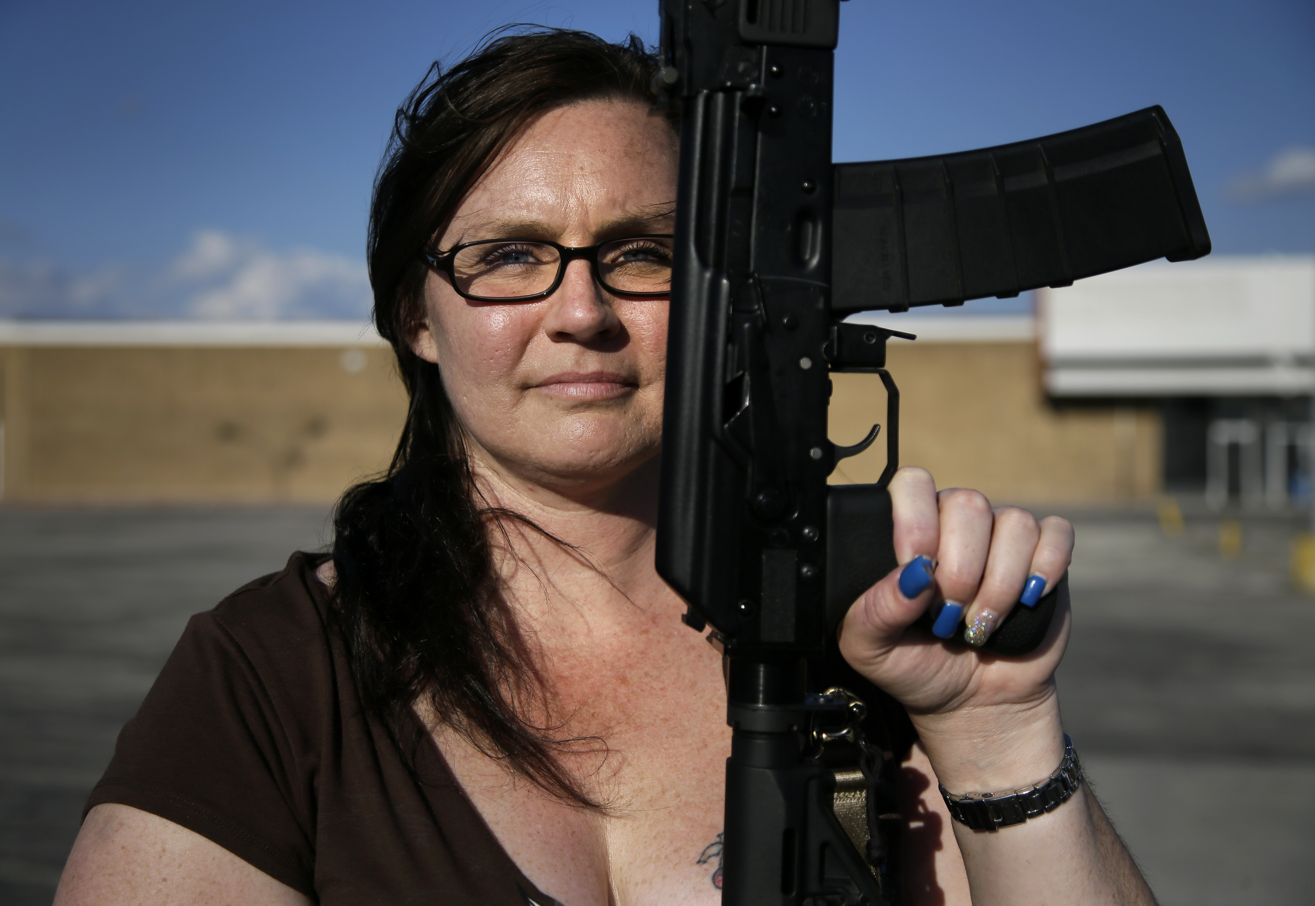 Tara Cowan poses as she and members of Open Carry Tarrant County gathered for a demonstration. North Texas gun rights advocates are suing Arlington for amending an ordinance they claim is discriminatory and infringes upon free speech rights, in the latest sign of tensions among gun activists and government forces in Texas. (Associated Press/Tony Gutierrez)
