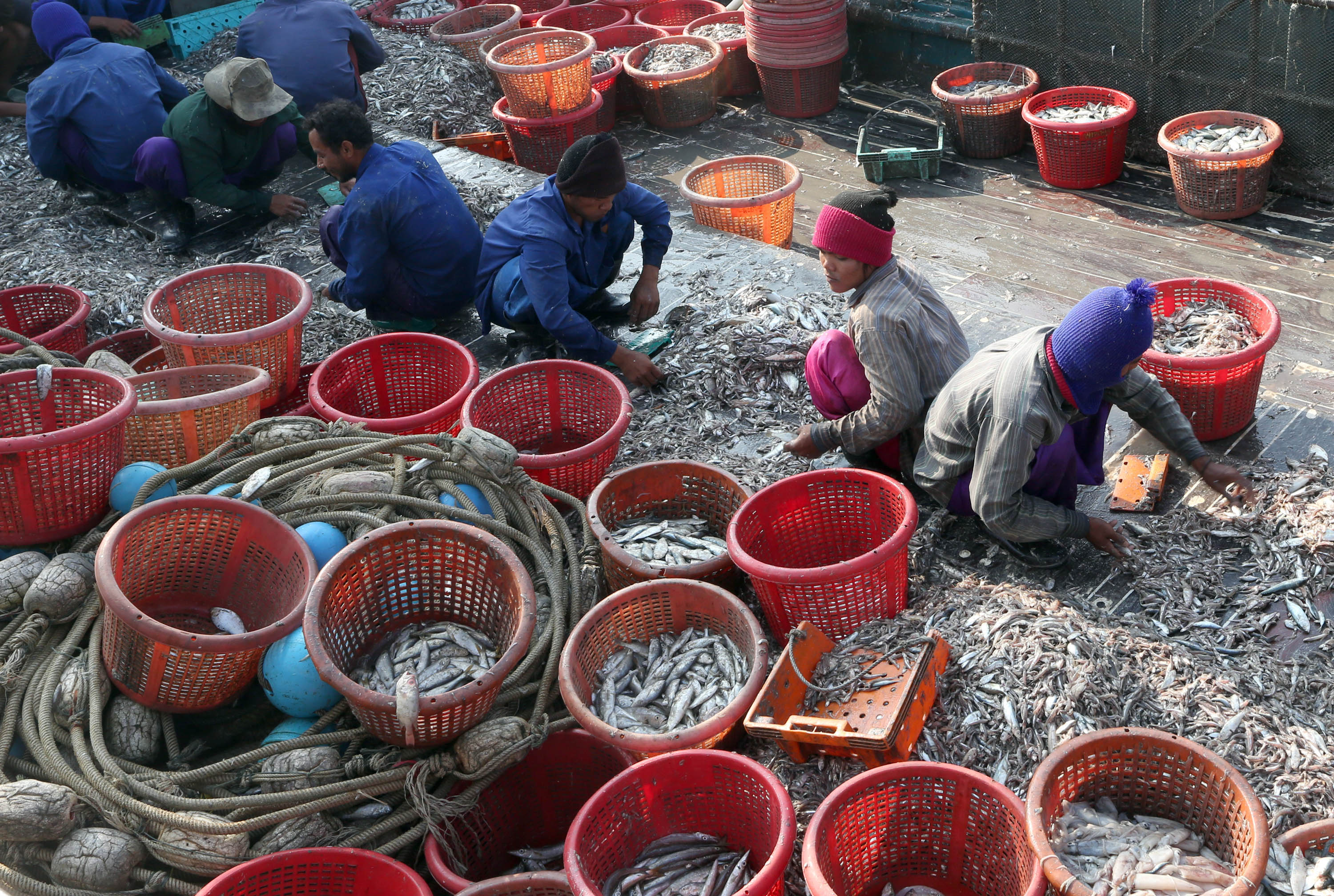 Myanmar workers work on a fishing boats at a pier in Prachuabkhirikhant province, southern Thailand Tuesday, March  4, 2014. (AP/Apichart Weerawong)