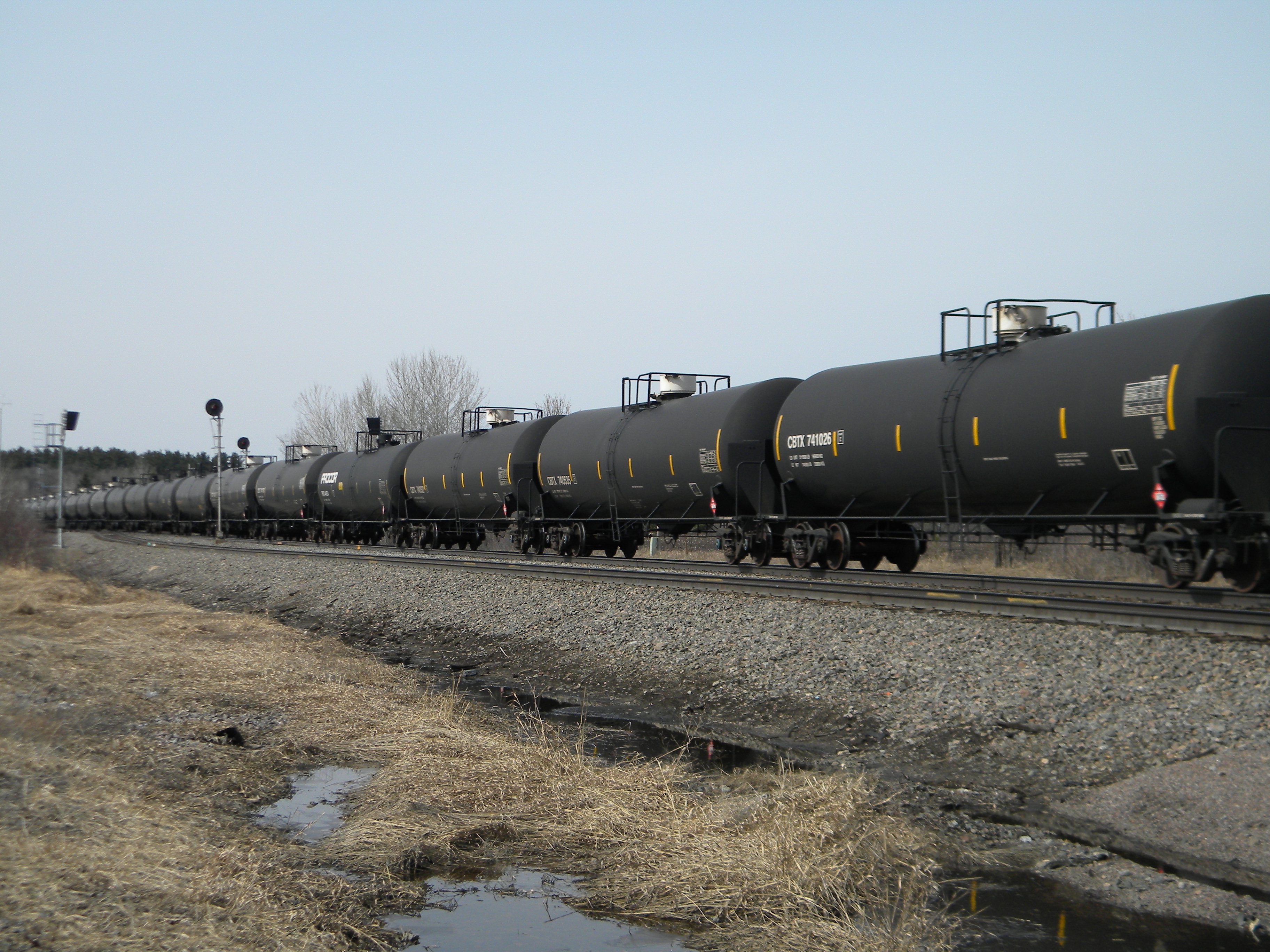 An oil-tank train operated by Burlington Northern Santa Fe Corp., based in Fort Worth, Texas, cruises east alongside U.S. 10, a few miles outside of Staples, Minn. (AP/Mike Cronin)