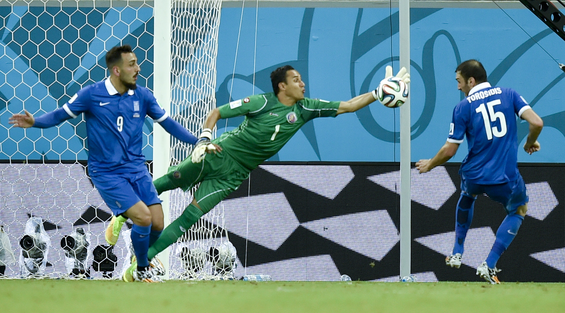 Costa Rica's goalkeeper Keylor Navas clears the ball away from Greece's Kostas Mitroglou (9) and Vasilis Torosidis during the World Cup round of 16 soccer match between Costa Rica and Greece at the Arena Pernambuco in Recife, Brazil, Sunday, June 29, 2014. (AP Photo/Martin Meissner) (Martin Meissner)