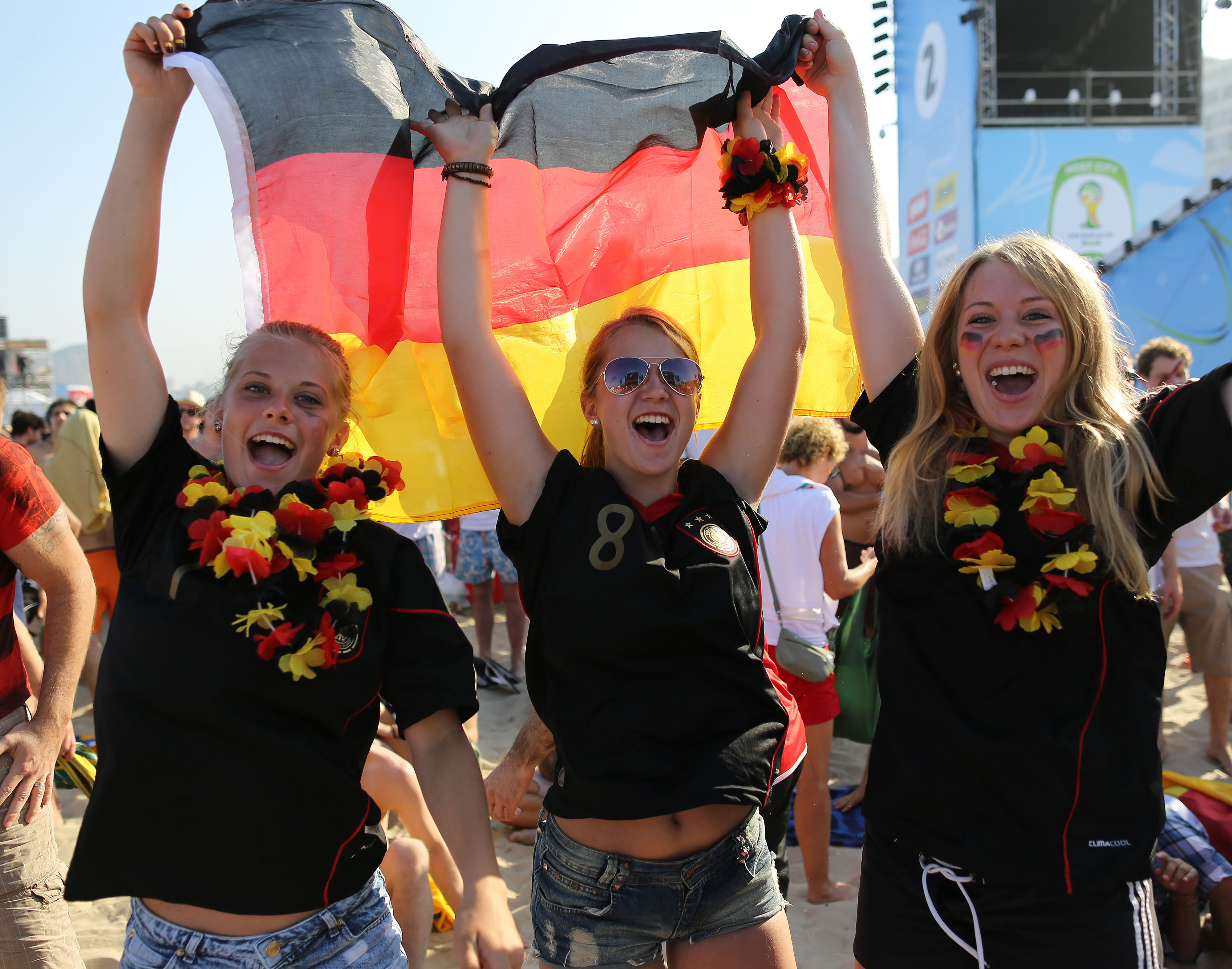 Soccer fans pose for a photo as they celebrate Germany's victory over Portugal at the end of a live broadcast of the World Cup match, inside the FIFA Fan Fest area on Copacabana beach, in Rio de Janeiro, Brazil, Monday, June 16, 2014. Germany routed Portugal 4-0 in their group G opener on Monday. (AP Photo/Leo Correa) (AP)