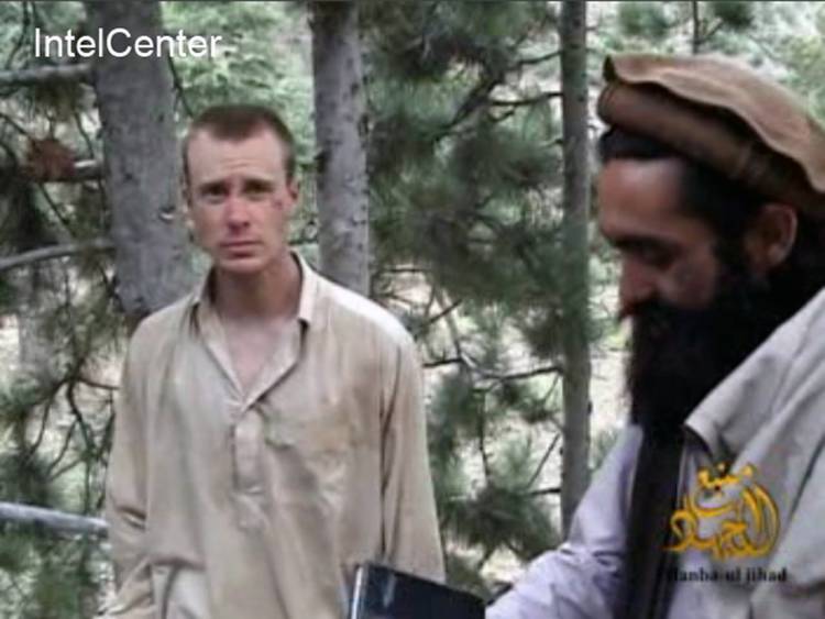 This image made from video released by the Taliban and obtained by IntelCenter on Dec. 8, 2010, shows a man believed to be Bowe Bergdahl at left (AP Photo/IntelCenter)