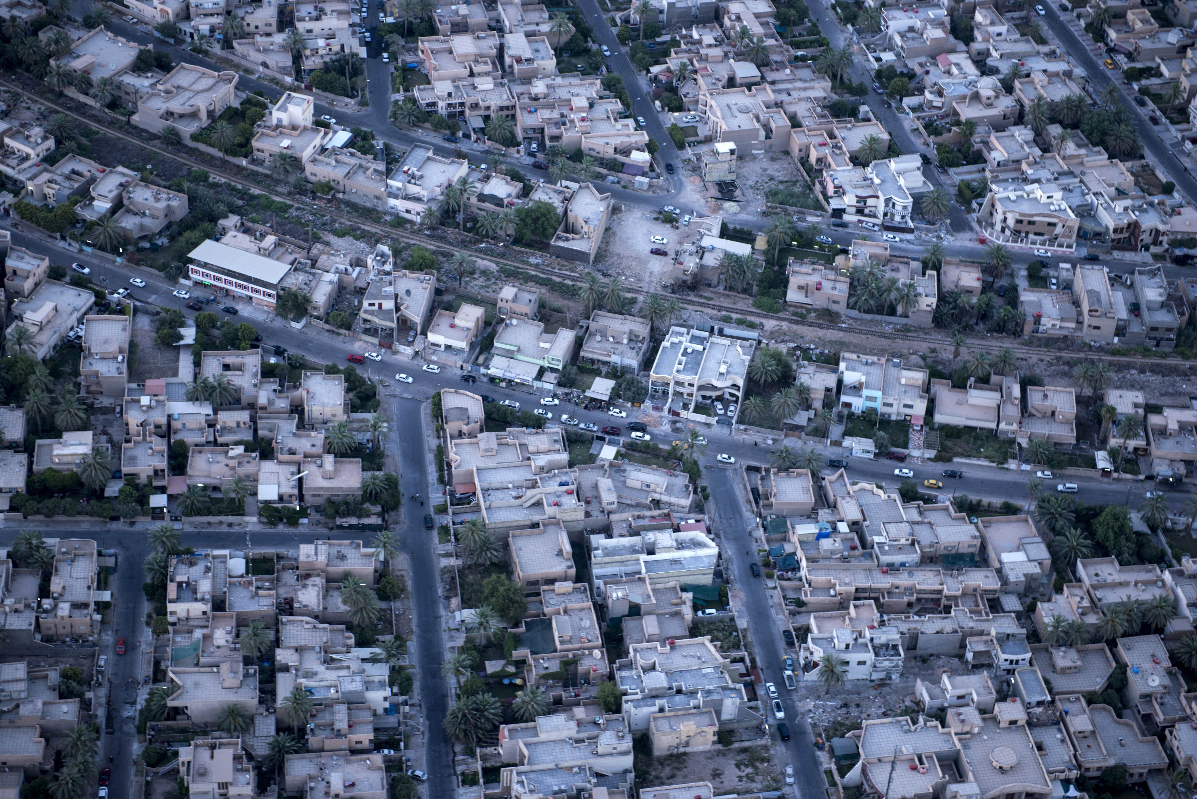 A photo taken on board a helicopter shows parts of the Iraqi capital Baghdad Monday, June 23, 2014 as US Secretary of State John Kerry pledged during a visit to the capital, "intense" support for Iraq against the "existential threat" of a major militant offensive pushing toward Baghdad from the north and west.  (AP Photo/Brendan Smialowski, Pool) (AP)