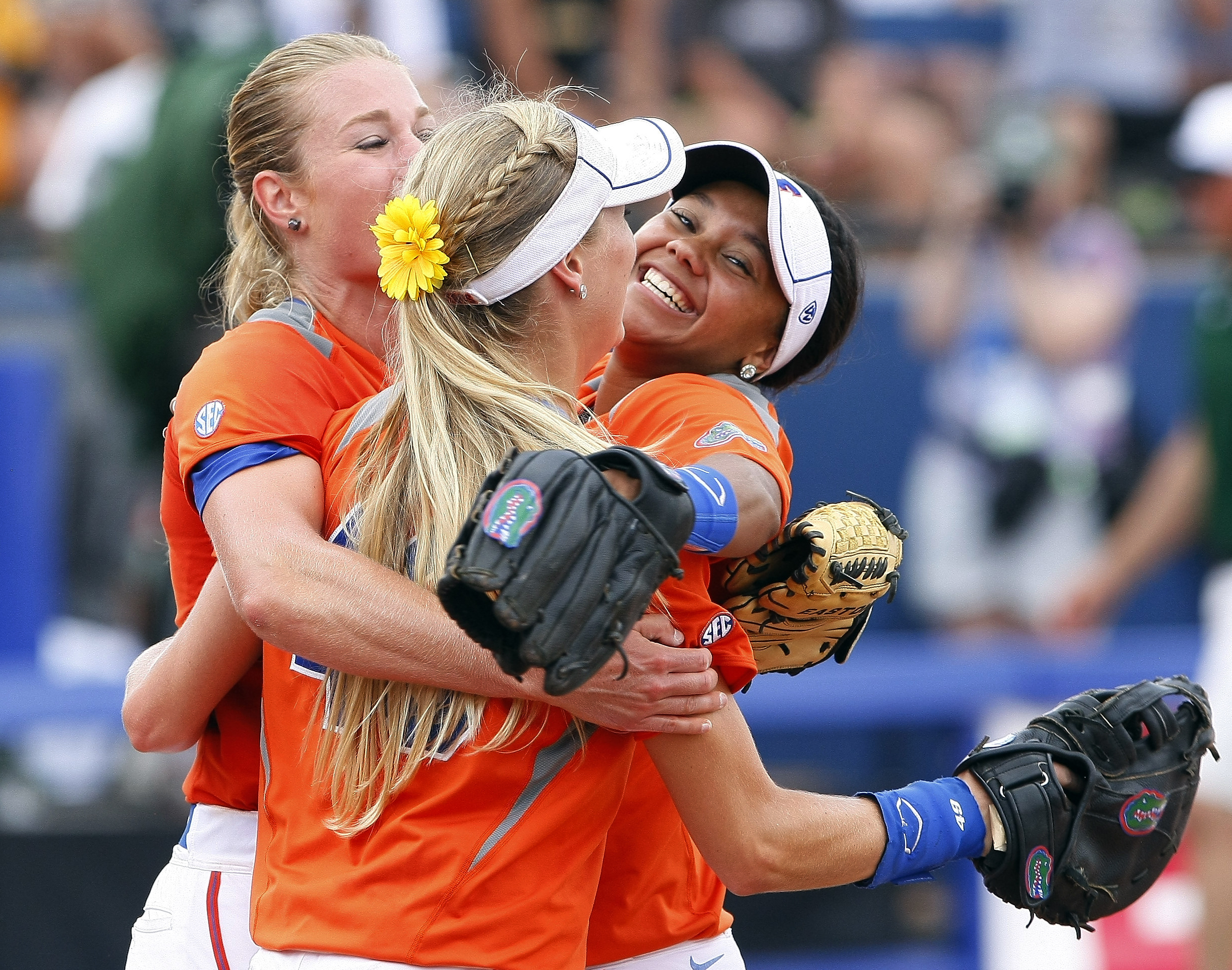 Florida pitcher Hannah Rogers, Taylor Schwarz, front, and Kelsey Stewart, right, celebrate after defeating Baylor during an NCAA women's softball College World Series tournament game, Sunday, June 1, 2014, in Oklahoma City. Florida won 6-3. (AP Photo/Alonzo Adams) (AP)