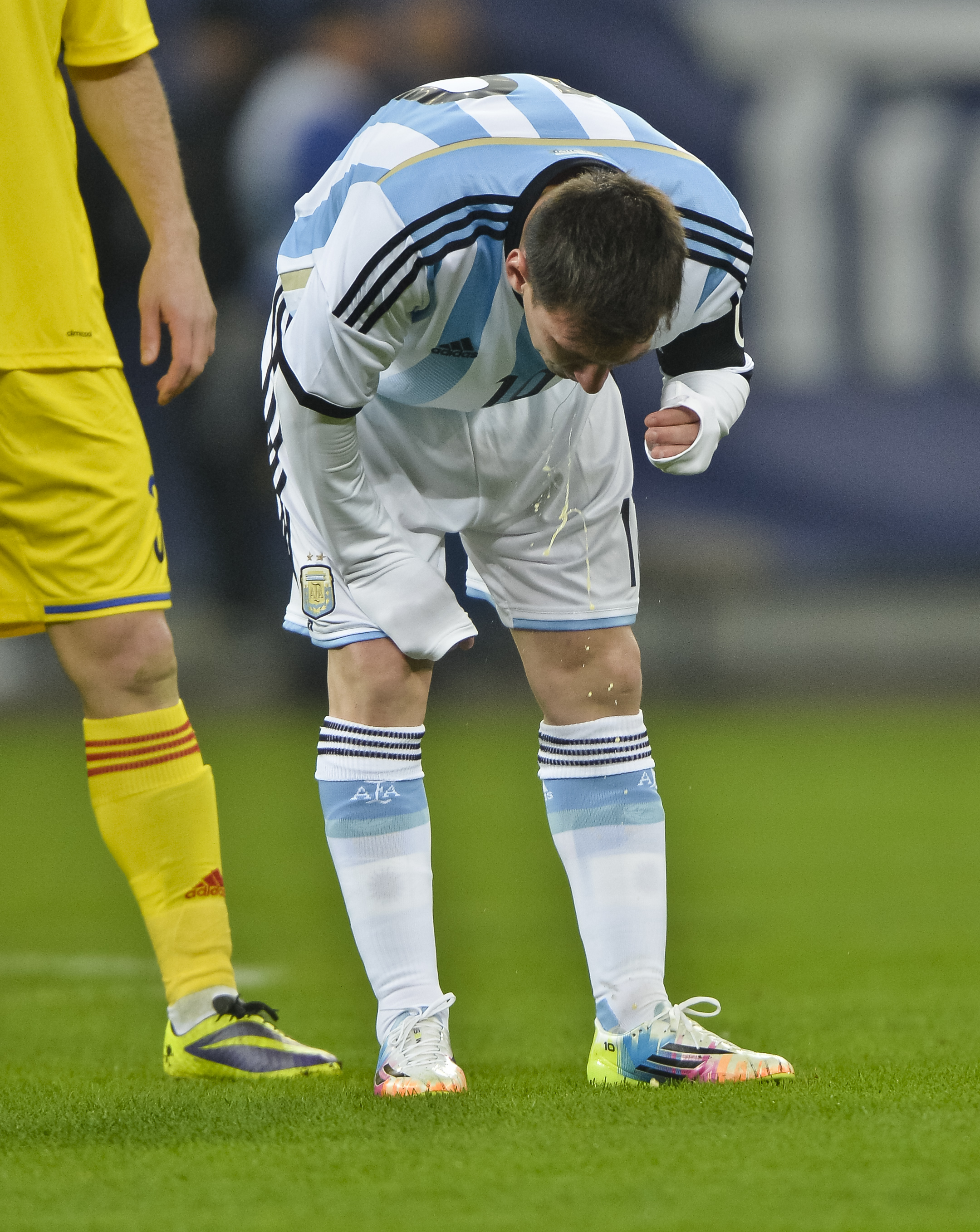 FILE - In this March 5, 2014 file photo, Argentina's Lionel Messi appears to vomit during an international friendly soccer game against Romania on the National Arena stadium in Bucharest, Romania. Messi has vomited at least a half-dozen times with Argentina and club team Barcelona, mystifying doctors and fans alike. (AP Photo, File) ROMANIA OUT (AP)