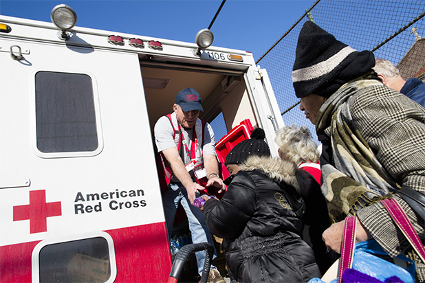 A member of the Red Cross distributes food to residents of Coney Island affected by Superstorm Sandy, Nov. 9, 2012. (AP/John Minchillo)
