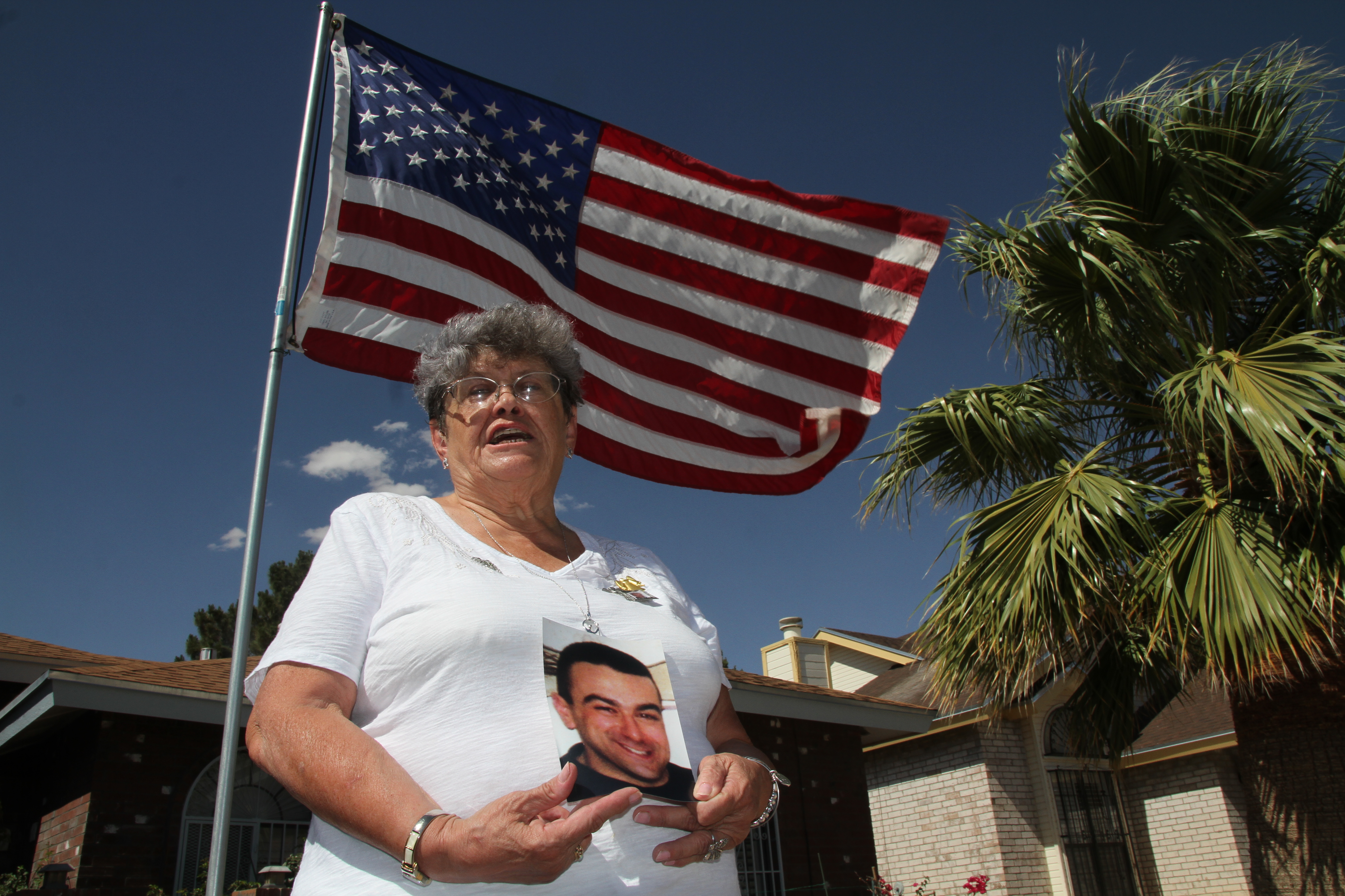 Lillian "Bonnie" D'Amico, poses for a photograph while holding a photo of her son Nicholas D'Amico in El Paso, Texas. Her son killed himself while waiting for a an appointment with a psychiatrist. (AP)