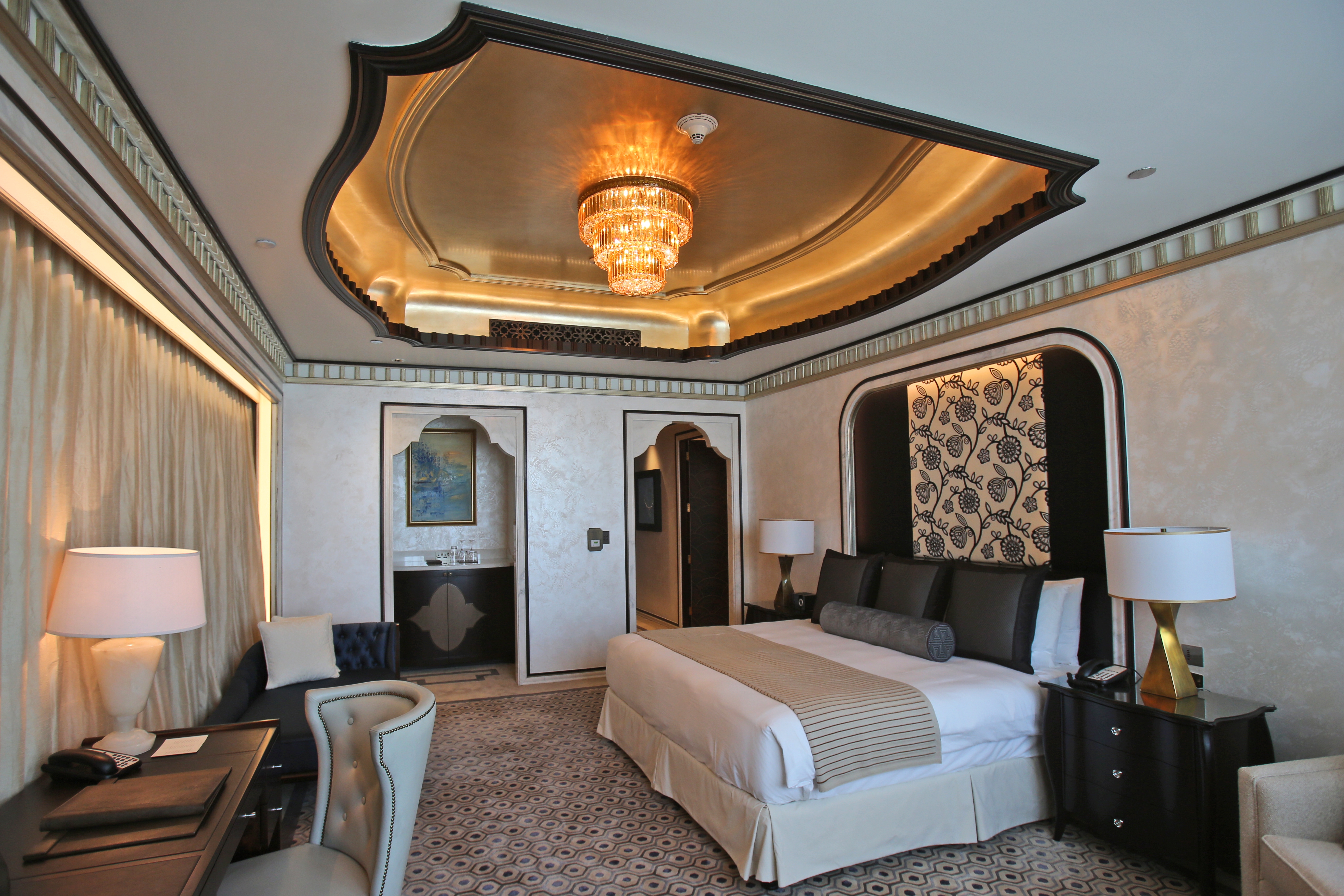 This May 19, 2014 photo shows one of the three bedrooms in the Abu Dhabi Suite at the St. Regis in Abu Dhabi, United Arab Emirates. The nearly 24,000 square foot two-story suite, which sells for a nightly rate of $21,500, is suspended 720 feet above ground between the two buildings of the Nation Towers development. It has three bedrooms, a spa, a cinema, a bar area, two kitchens and a 360-degree panoramic view of the city, the islands, and the Sheikh Zayed Grand Mosque. The suite has 19 chandeliers made of Bohemian crystal, and an elevator that takes guests to ground level in total privacy, bypassing the rest of the hotel. (AP Photo/Kamran Jebreili)