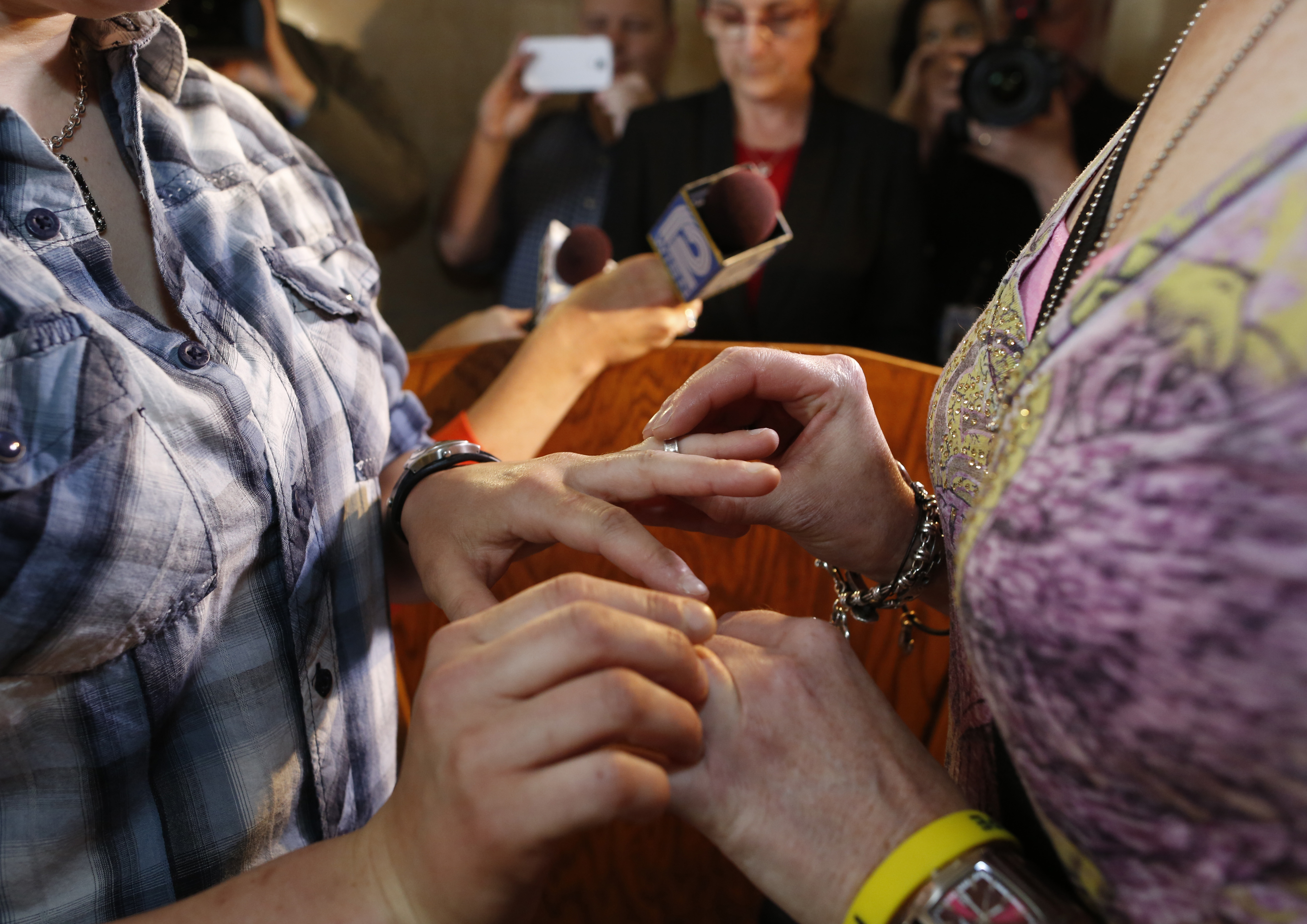 Jill Winkler, left, and Pamela Dietzler exchange rings as they are married at the Milwaukee County Courthouse June 6, 2014, in Milwaukee. Same-sex couples began getting married in Wisconsin on Friday shortly after a federal judge struck down the state's gay marriage ban and despite confusion over the effect of the ruling.  (AP Photo/Jeffrey Phelps) (AP)