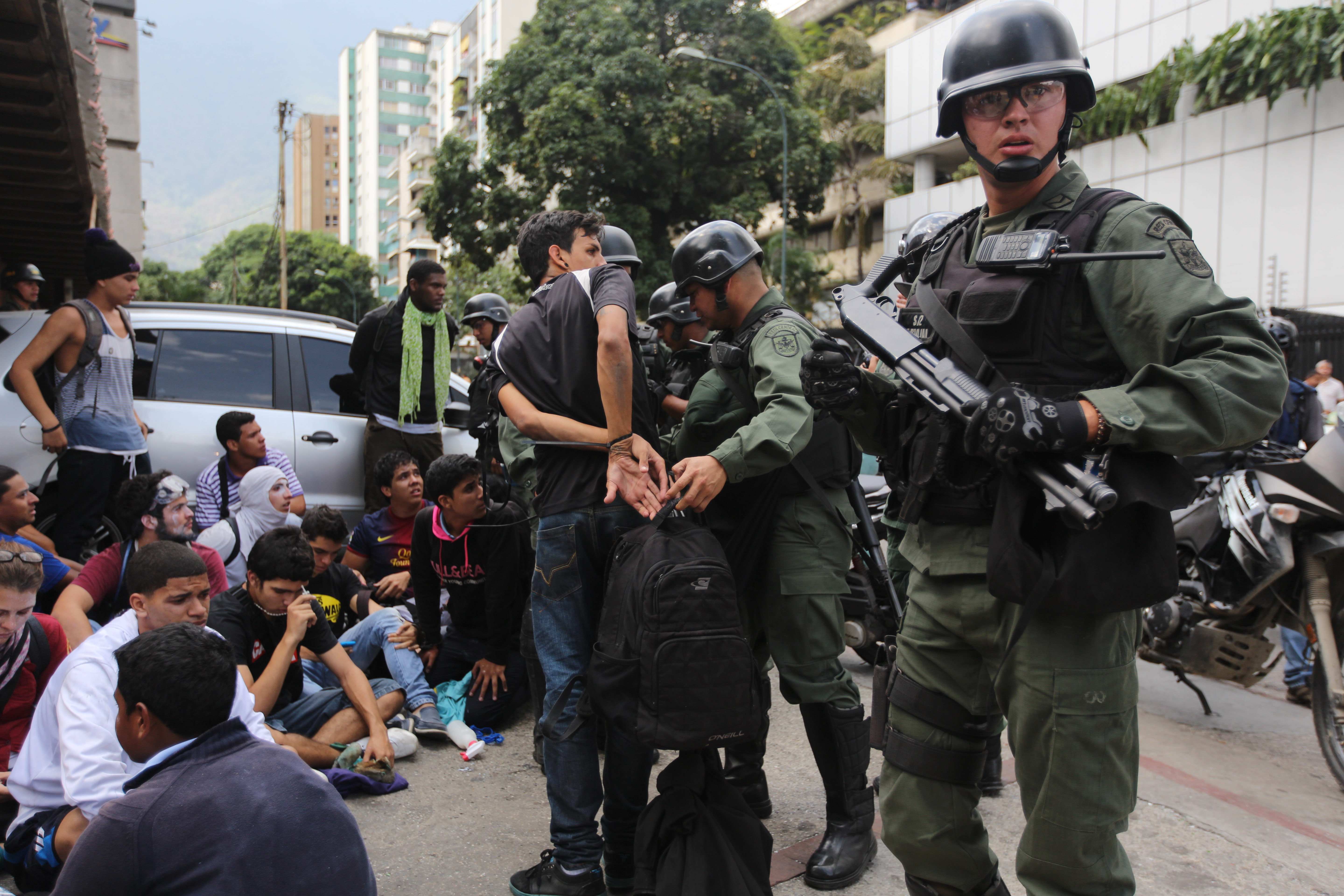An anti-government demonstrator is handcuffed after he and others where detained by the Bolivarian National Guard, during clashes at a protest in Caracas, Venezuela, Wednesday, May 14, 2014. (AP/Fernando Llano)