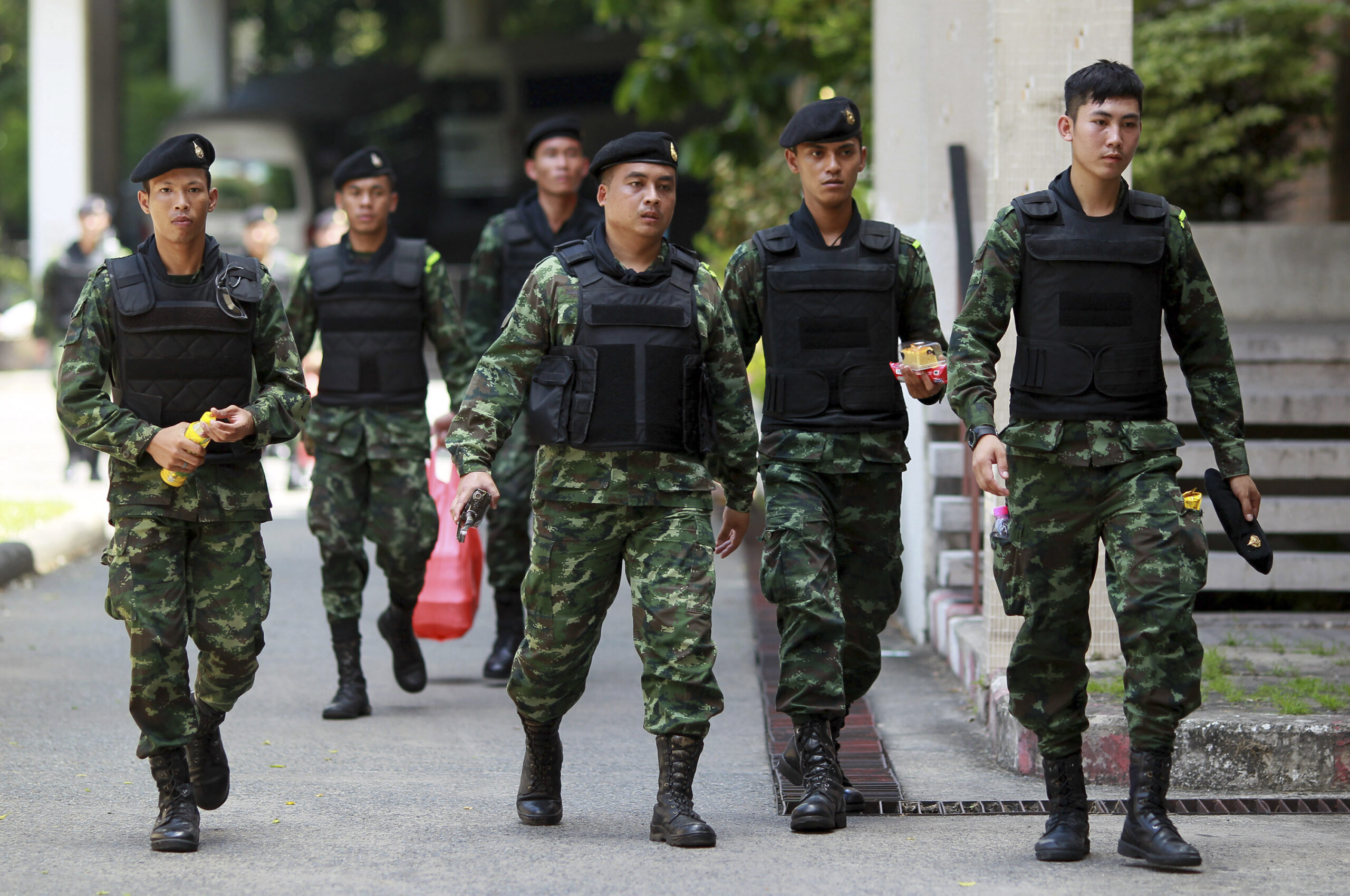 Thai soldiers walk after being deployed to guard in Bangkok's Victory Monument, Thailand Sunday, June 8, 2014. (AP/Wason Wanichakorn)