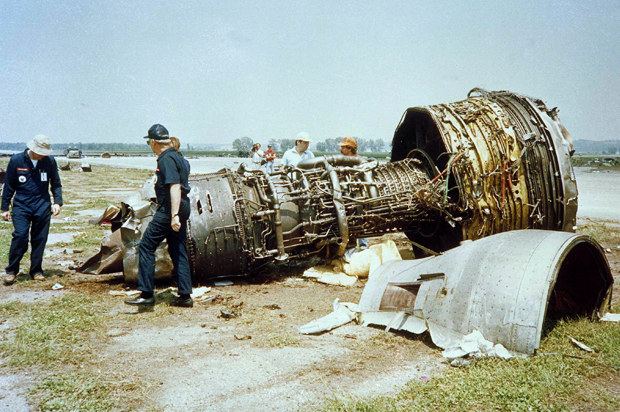 Investigators for the National Transportation Safety Board look over one of the burned jet engines of a United Airlines DC-10 that crashed  while trying to make an emergency landing on July 19, wreckage shown July 22, 1989. There are 109 confirmed deaths in the tragedy. (AP Photo/Sioux City Journal Pool/Ed Porter) (Ed Porter)