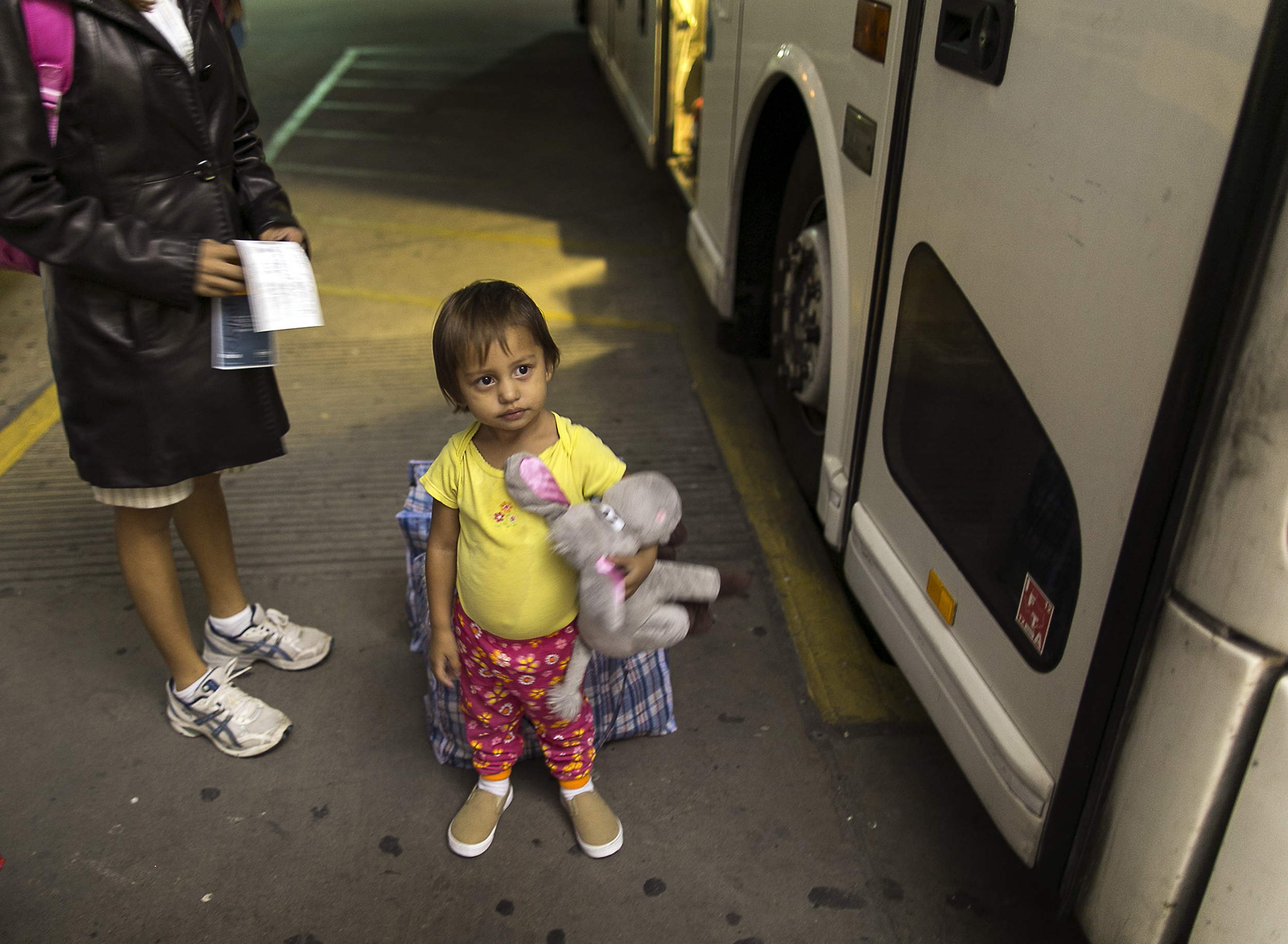 In this photo taken July 1, 2014, two-year-old Adriana Ortez holds her stuffed animal, as she and her mother, Dayana Ortez, of El Salvador, wait to board a bus leaving the city bus station in McAllen, Texas. Ortez and her daughter, were released on their own recognizance by U.S. Customs and Border Protection Services after entering the illegally into the U.S. from Mexico. The mother and daughter were heading to Los Angles to reunite with family. (AP Photo/Austin American-Statesman, Rodolfo Gonzalez) (AP)