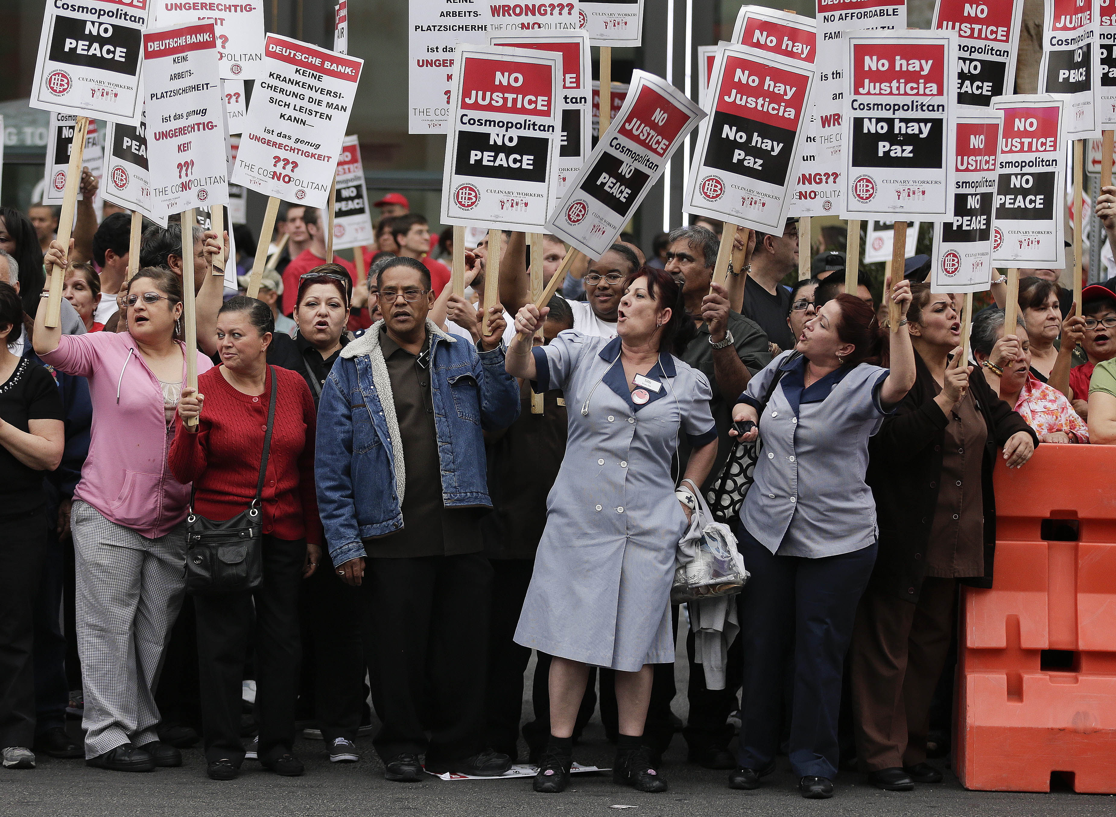 FILE - This March 20, 2013, file photo shows Culinary Union workers demonstrating along Las Vegas Boulevard, protesting against their contract negotiations with Deutsche Bank in Las Vegas. (AP Photo/Julie Jacobson, File)