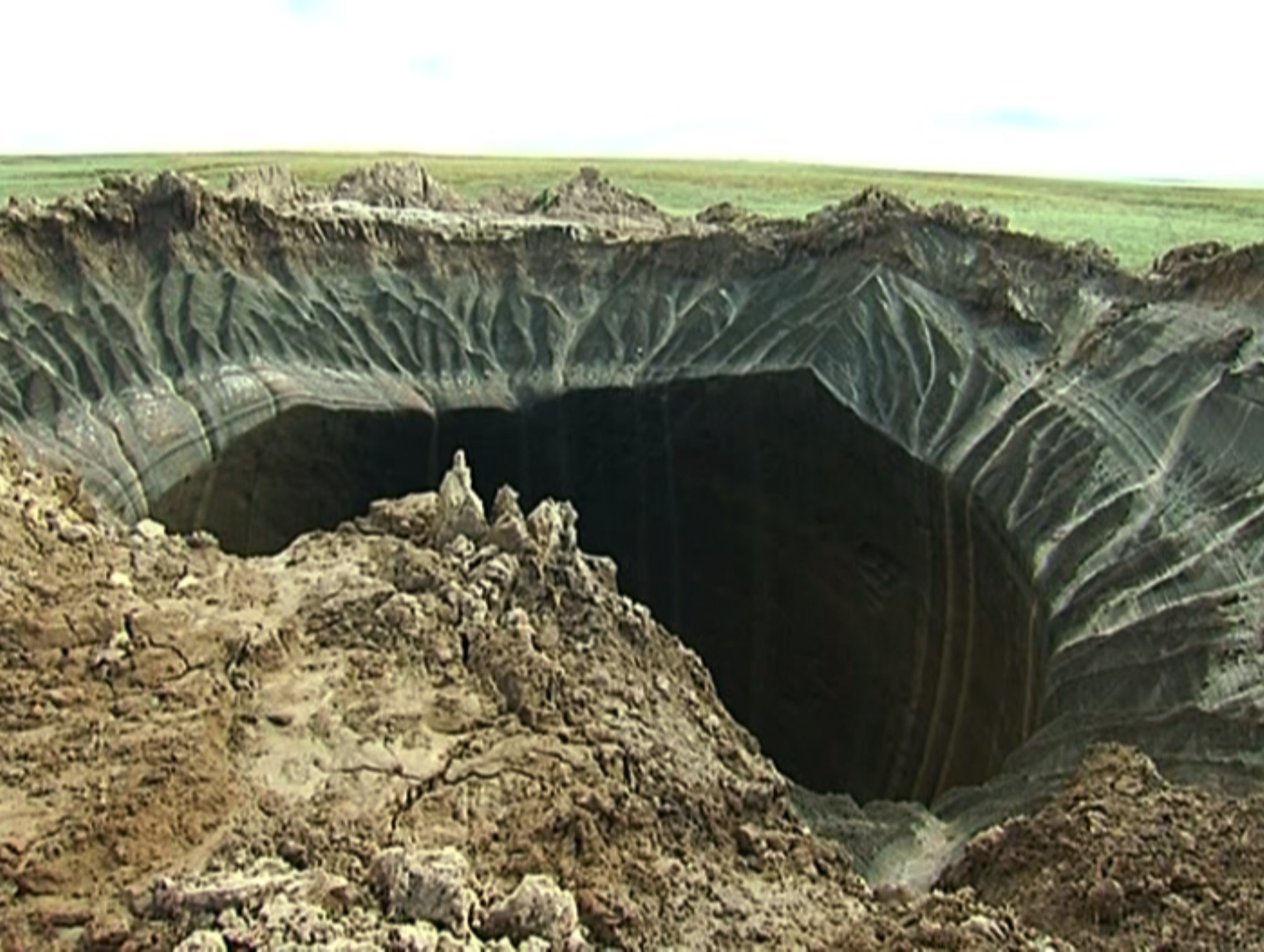 This frame grab made Wednesday, July 16, 2014, shows a crater, discovered recently in the Yamal Peninsula, in Yamalo-Nenets Autonomous Okrug, Russia. (AP Photo/Associated Press Television) (AP)
