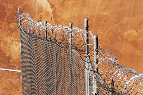 Chain link fence with razor wire.
