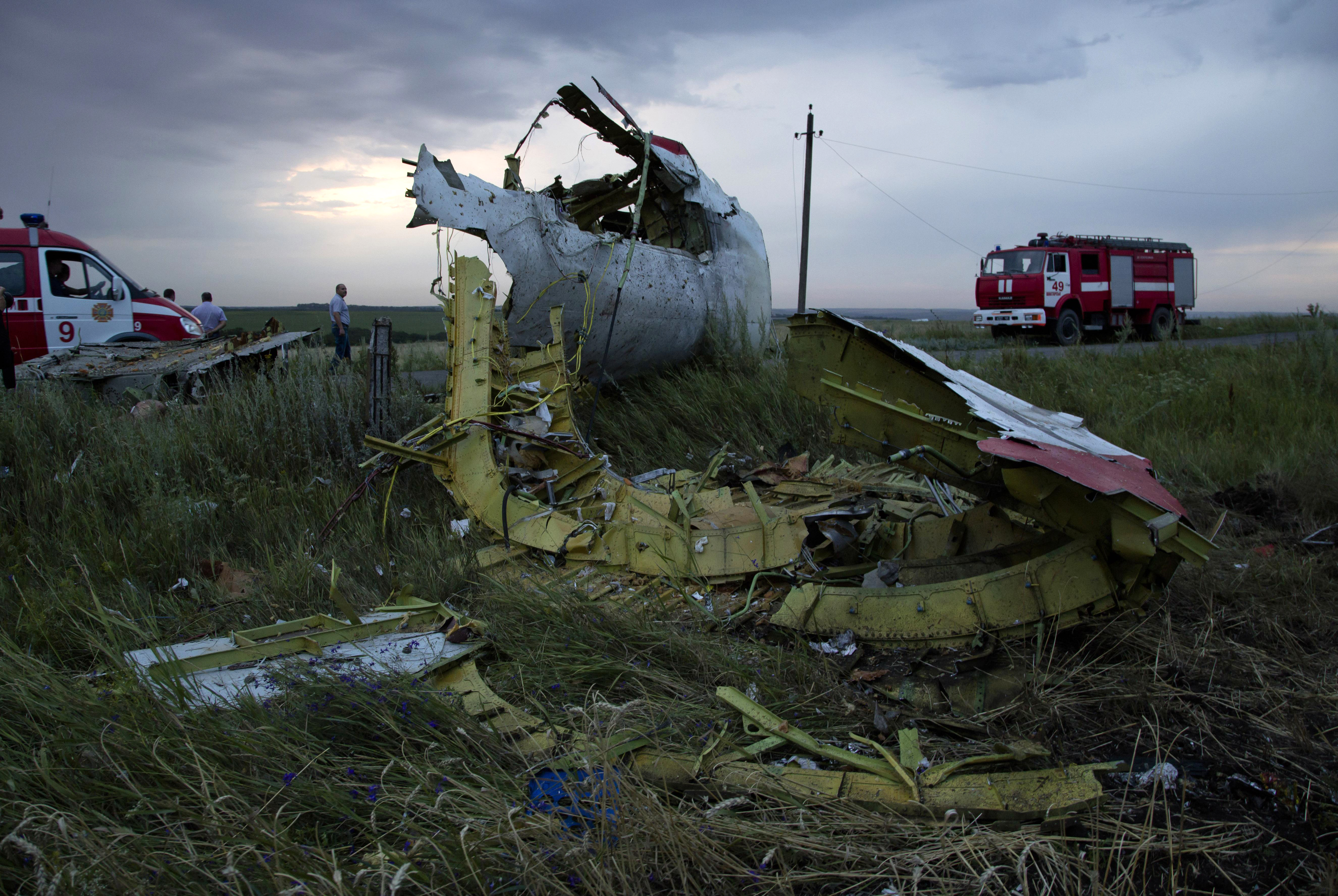 Fire engines arrive at the crash site of a passenger plane near the village of Hrabove, Ukraine, as the sun sets Thursday, July 17, 2014. Ukraine said a passenger plane carrying 295 people was shot down Thursday as it flew over the country, and both the government and the pro-Russia separatists fighting in the region denied any responsibility for downing the plane. ((AP Photo/Dmitry Lovetsky))