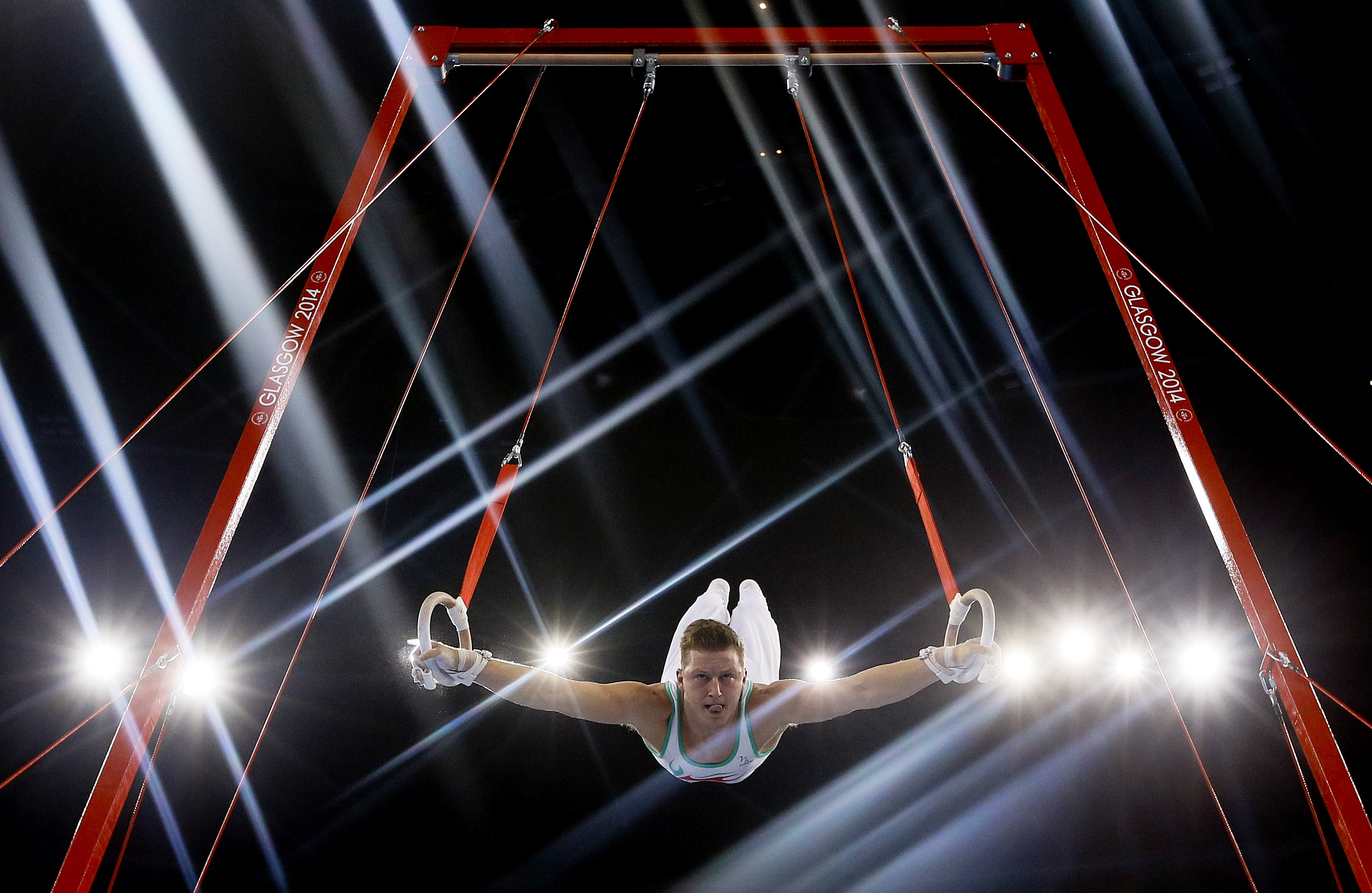 10ThingstoSeeSports - Lights flare as Harry Owen of Wales performs on the rings during the Men's All-Around gymnastics competition at the Scottish Exhibition Conference Centre during the Commonwealth Games 2014 in Glasgow, Scotland, Wednesday, July 30, 2014. (AP Photo/Kirsty Wigglesworth, File) (AP)