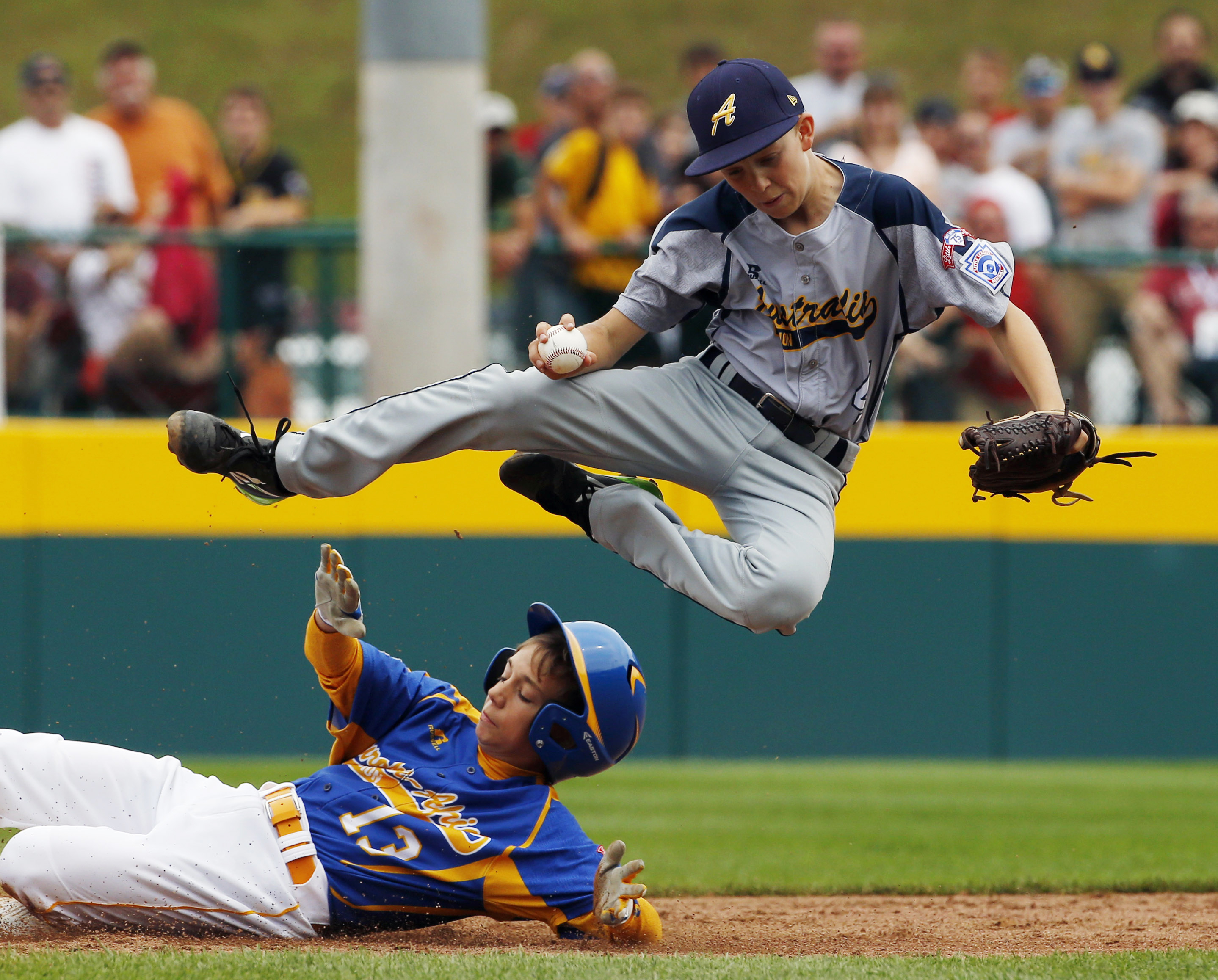 10ThingstoSeeSports - Australias Calvin Eissens, top, is sent flying after forcing out Czech Republics Marek Krejcirik at second base on a fielder's choice by Patrik Kadrnozka during the third inning of a baseball game at the Little League World Series, Saturday, Aug. 16, 2014, in South Williamsport, Pa. Australia won 10-1. (AP Photo/Matt Slocum, File) (AP)